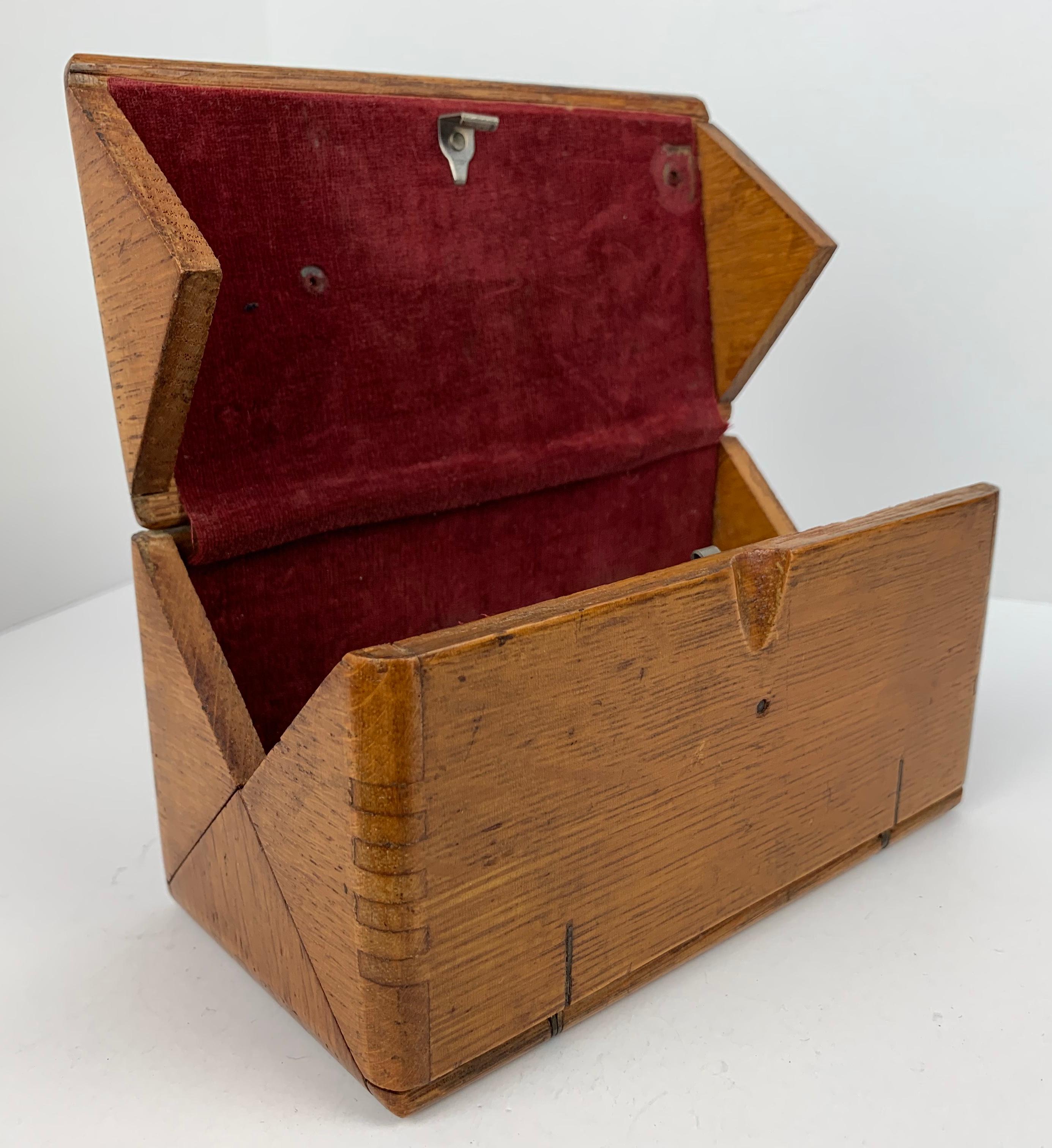 American dovetailed oak puzzle box. The top is dated within an oval cartouche 