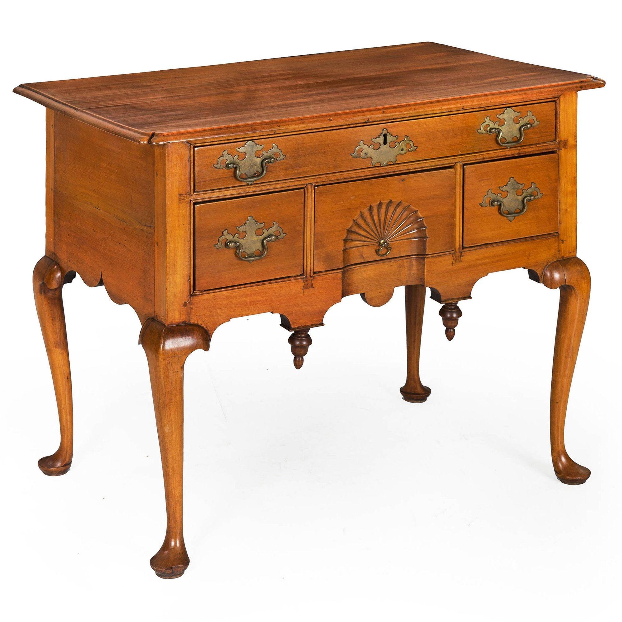 A good Queen Anne dressing table crafted entirely of cherrywood primaries featuring a rectangular top with an integral thumb-molded edge and inverted front corners projecting over a single full-width frieze drawer over a central fan-carved drawer