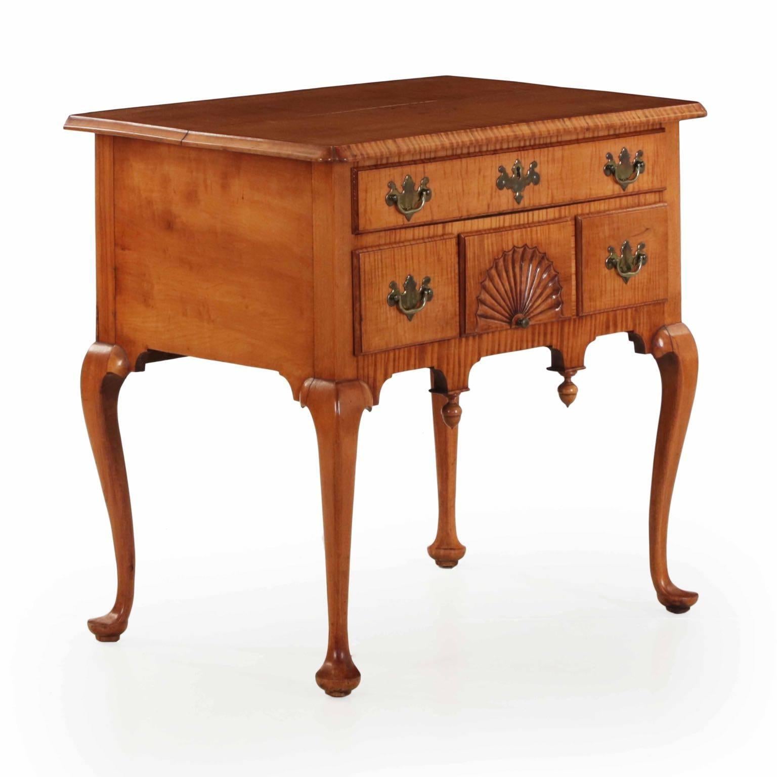 An incredibly striking lowboy from the last quarter of the 19th century, it is carefully bench made and closely inspired by the original forms of Connecticut. The case is crafted of solid tiger maple, the vibrant rays fully on display in the cut of