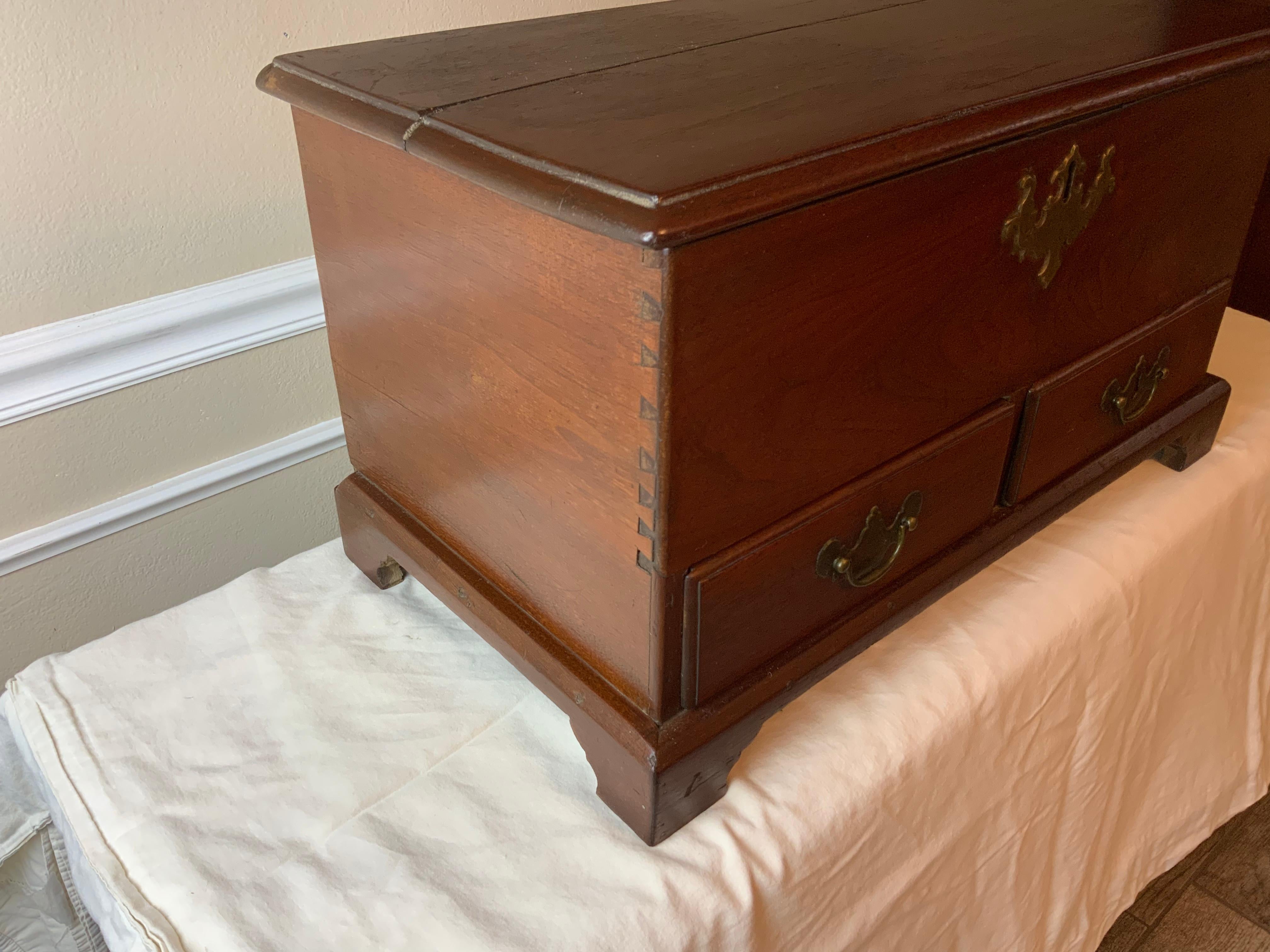18th Century diminutive or child’s size Walnut Queen Anne blanket chest likely of Virginia or Pennsylvania origin.  This is a very nicely proportioned piece with great character.  The lock and brasses which although look to be period could be later
