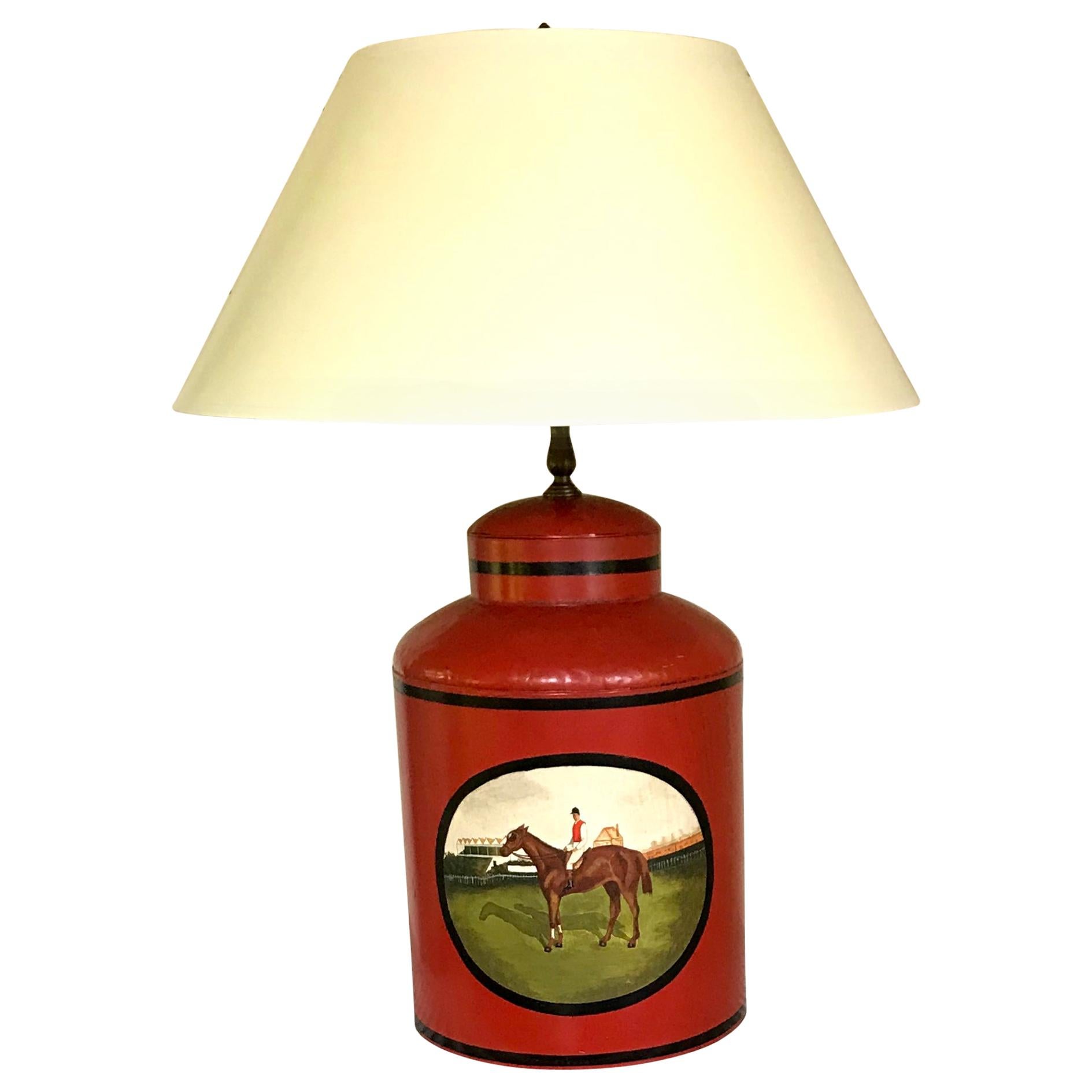 Derby tole horse lamp. American summer at the races tole milk jug painted red ground with black banding centering on a jockey astride a racehorse with viewing stand in the background. For the equestrian householder. Perfect at Pimlico, Hialeah,