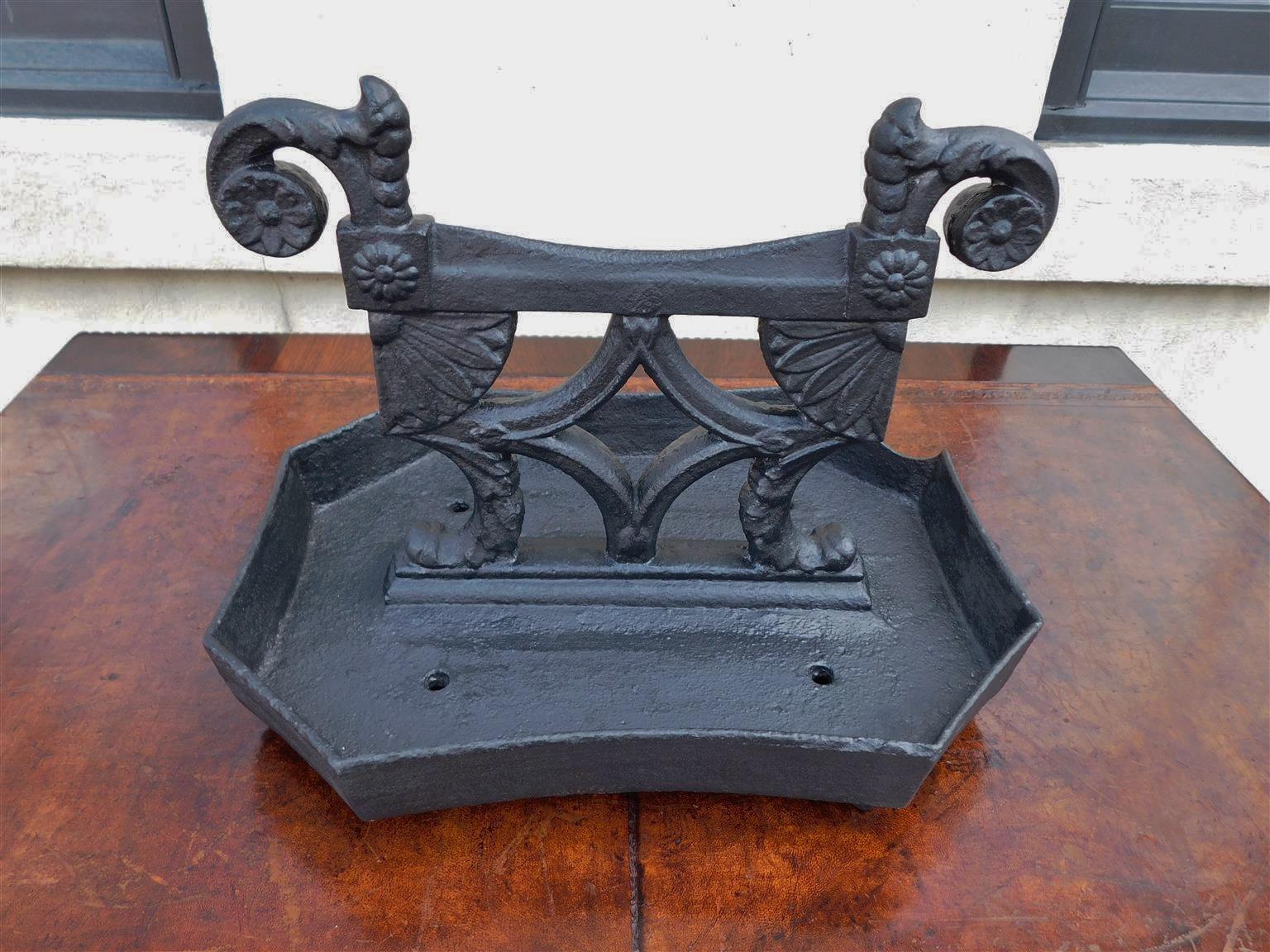 American Regency cast iron scrolled foliage medallion boot scrape resting on a canted corner rectangular base, Early 19th century