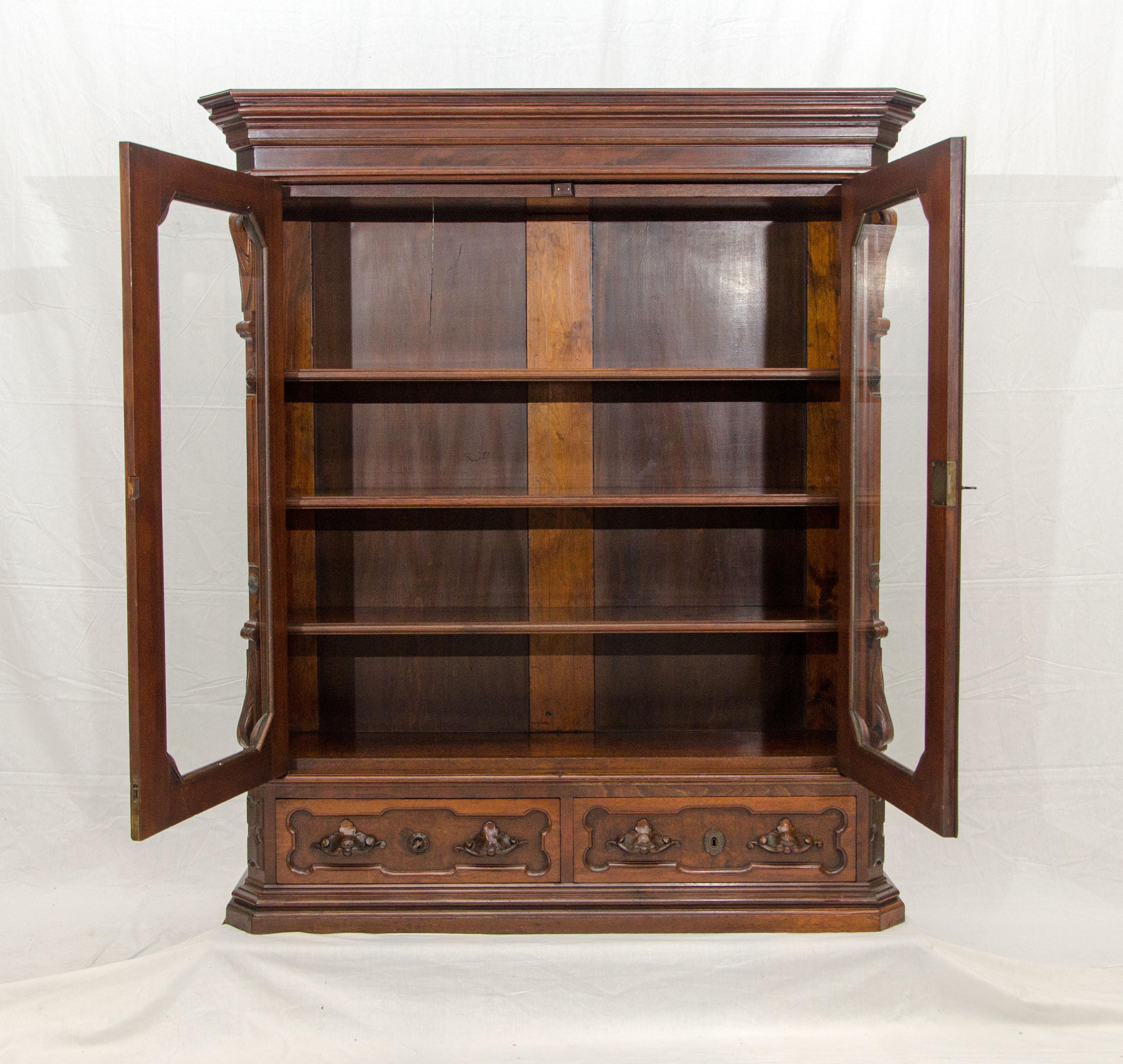 Very nice late 1800s American Victorian bookcase with two glass front doors and two storage drawers below. The inside height of the drawers is 5