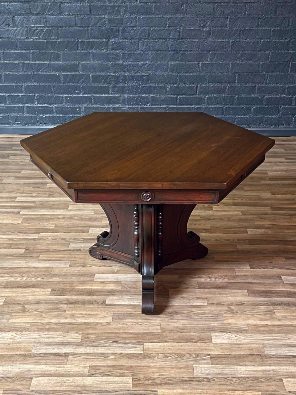 Condition: Original Vintage Condition
Designer: Riner Furniture Co. 
Manufacturer: Riner Furniture Co.

This American Revival hexagonal table by Riner Furniture showcases the rich craftsmanship and ornate detailing that defined early 20th-century