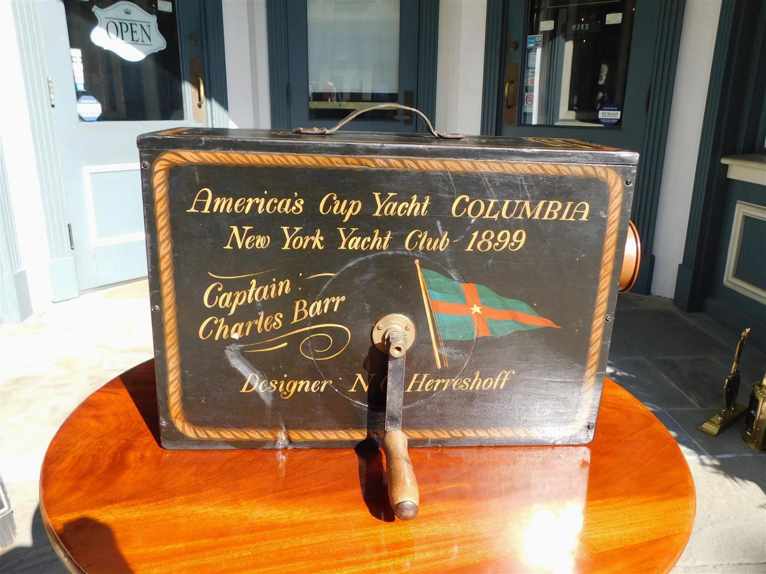 American Rotary nautical foghorn with a decorative painted rope pine case, exposed corner dovetailing, original leather strap, brass side crank, and original brass trumped horn. Fog horn is stenciled with America's Cup Yacht, COLUMBIA, New York