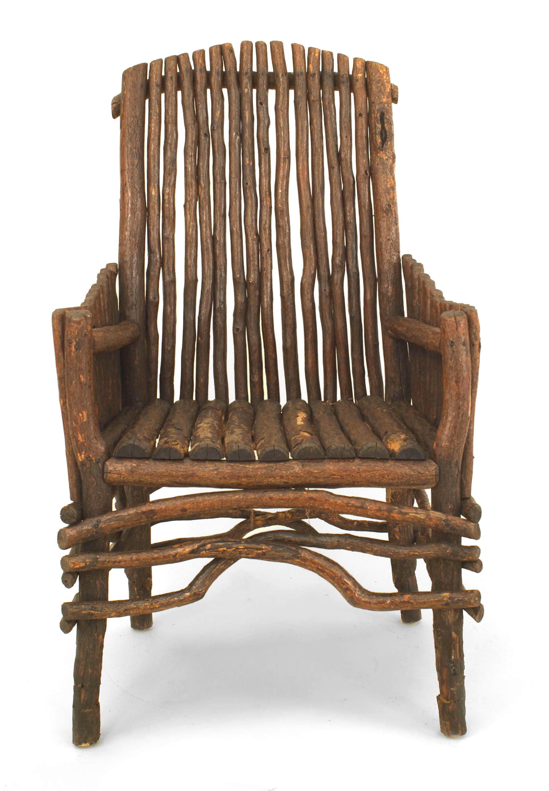 American Rustic Adirondack (1st qtr 20th Cent) slat twig design arm chair with an arch form high back and solid slat twig sides with a root stretcher.
