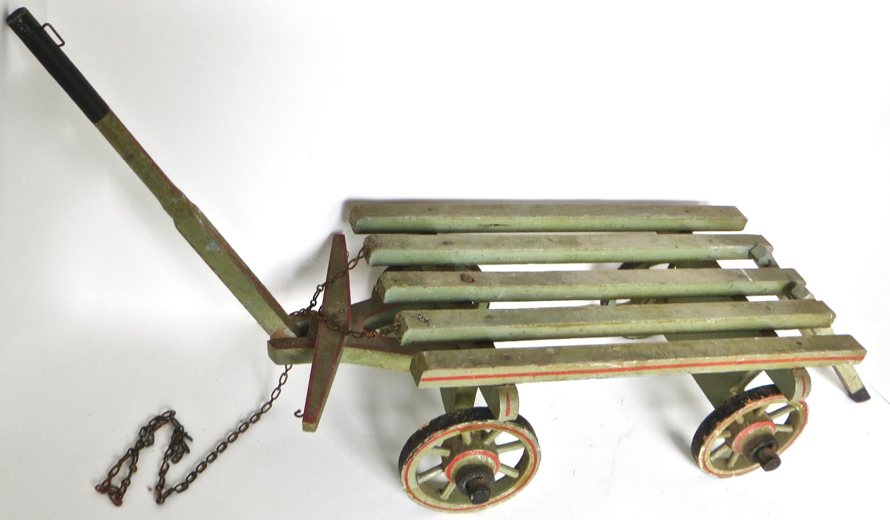 Salesman Sample : Late 19th century. American (4) wheeled hand carved all wooden horse drawn flat bed cargo wagon, in excellent condition with original red stenciling to the wheels, the chassis, the sides of the bed, and the rear ladder. Black