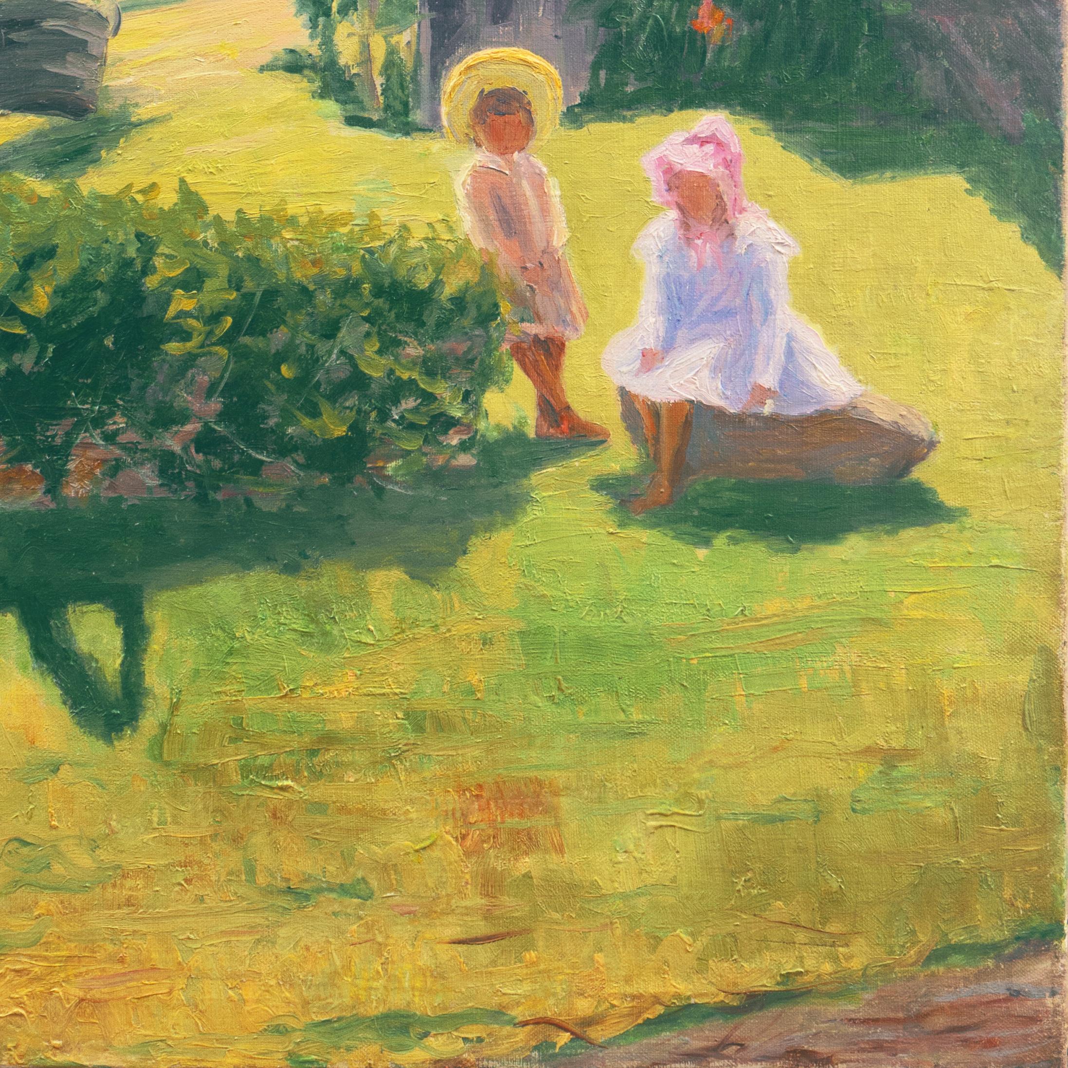 A substantial, early twentieth-century oil showing two children, wearing period summer dress and posed beside a well, with a view beyond across lush green lawns towards a substantial Arts and Crafts style house with a stand of trees in the distance;