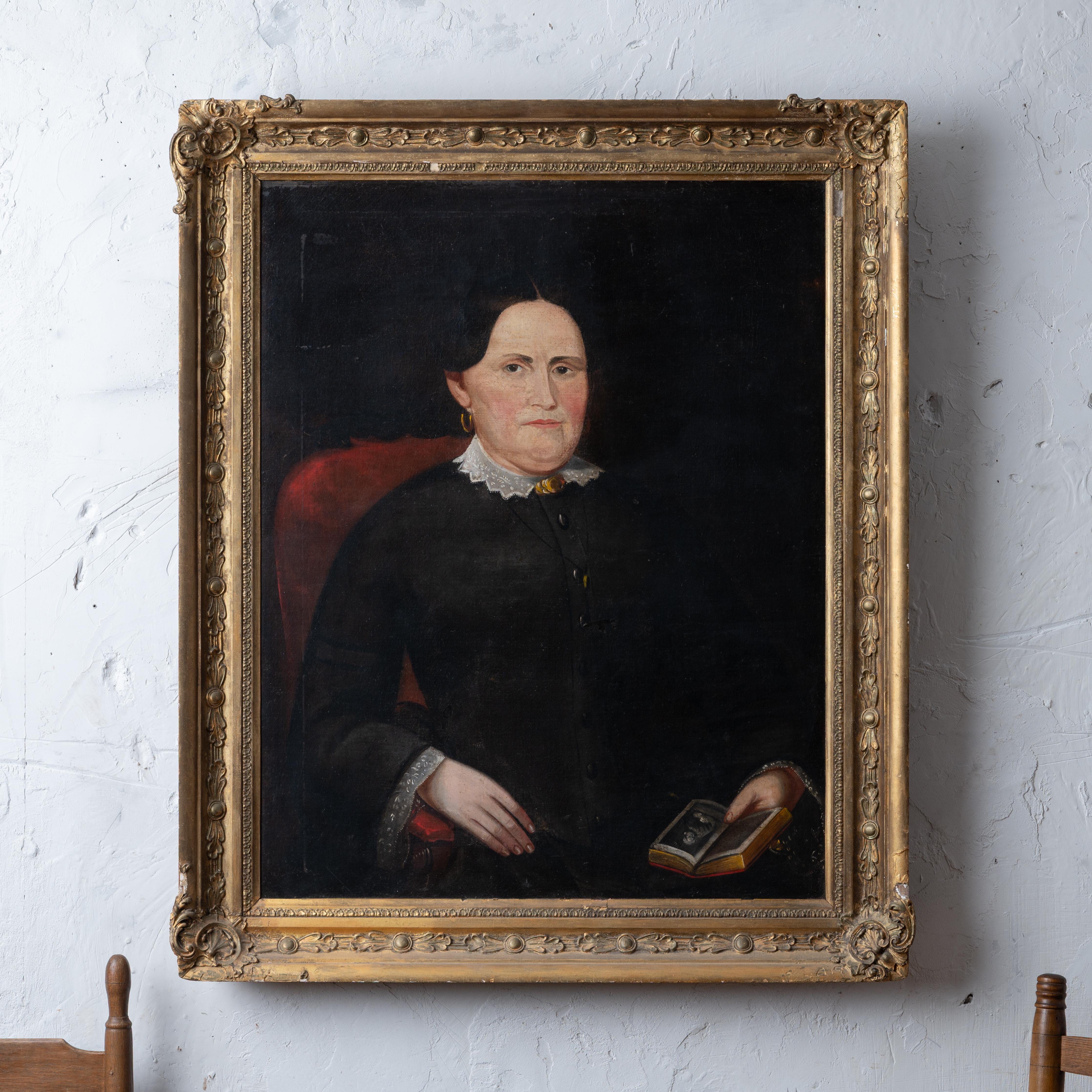 An American school oil on canvas portrait of a lady with a book; the book opened to an image of another portrait.  
Verso with stenciled canvas supplier William Wisong of Baltimore and prepared by color man Edward Dechaux of New York.  Another