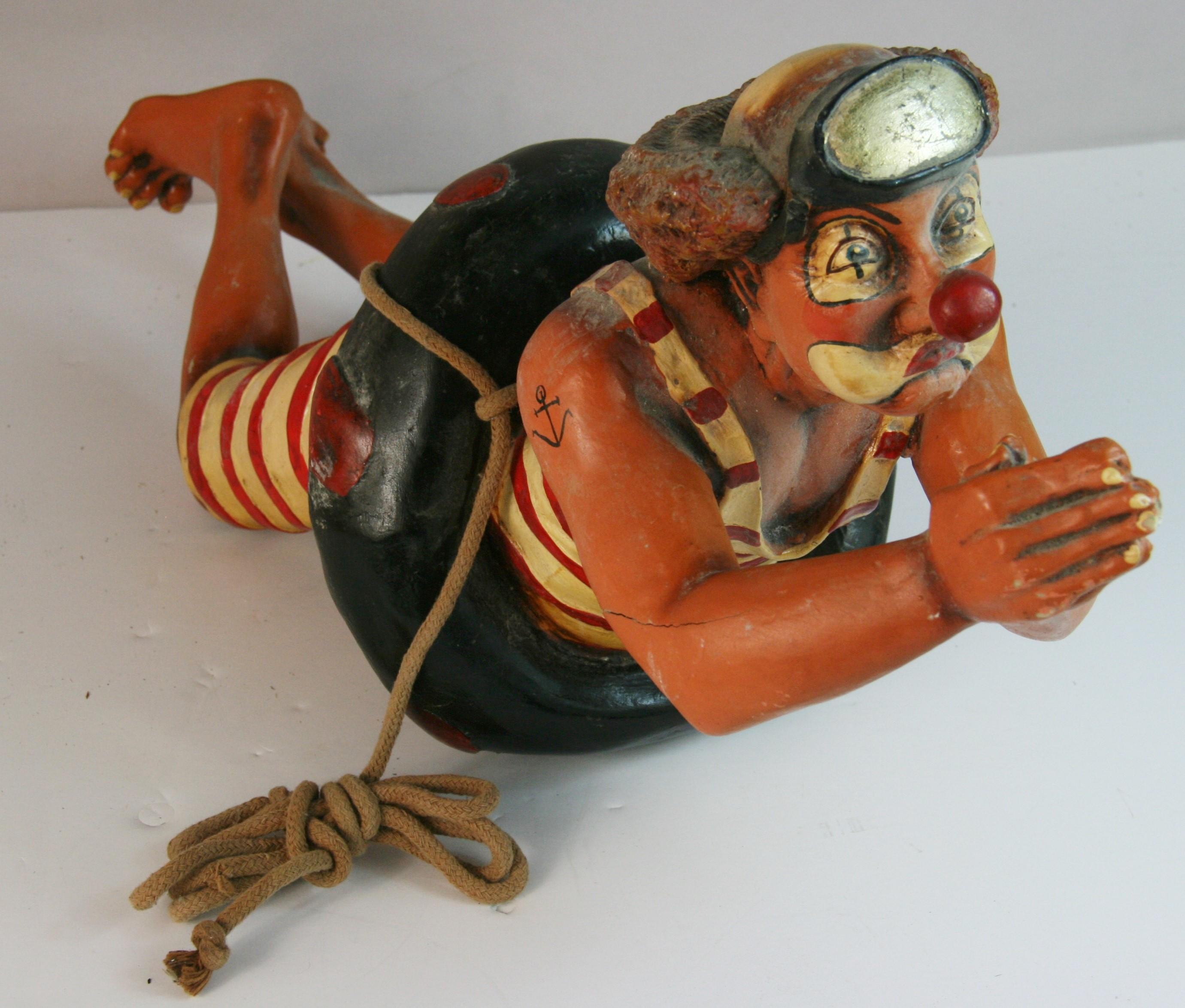 1706 American hand cast and painted whimscal sculpture of a man ina 1920's swimsuite in a life raft