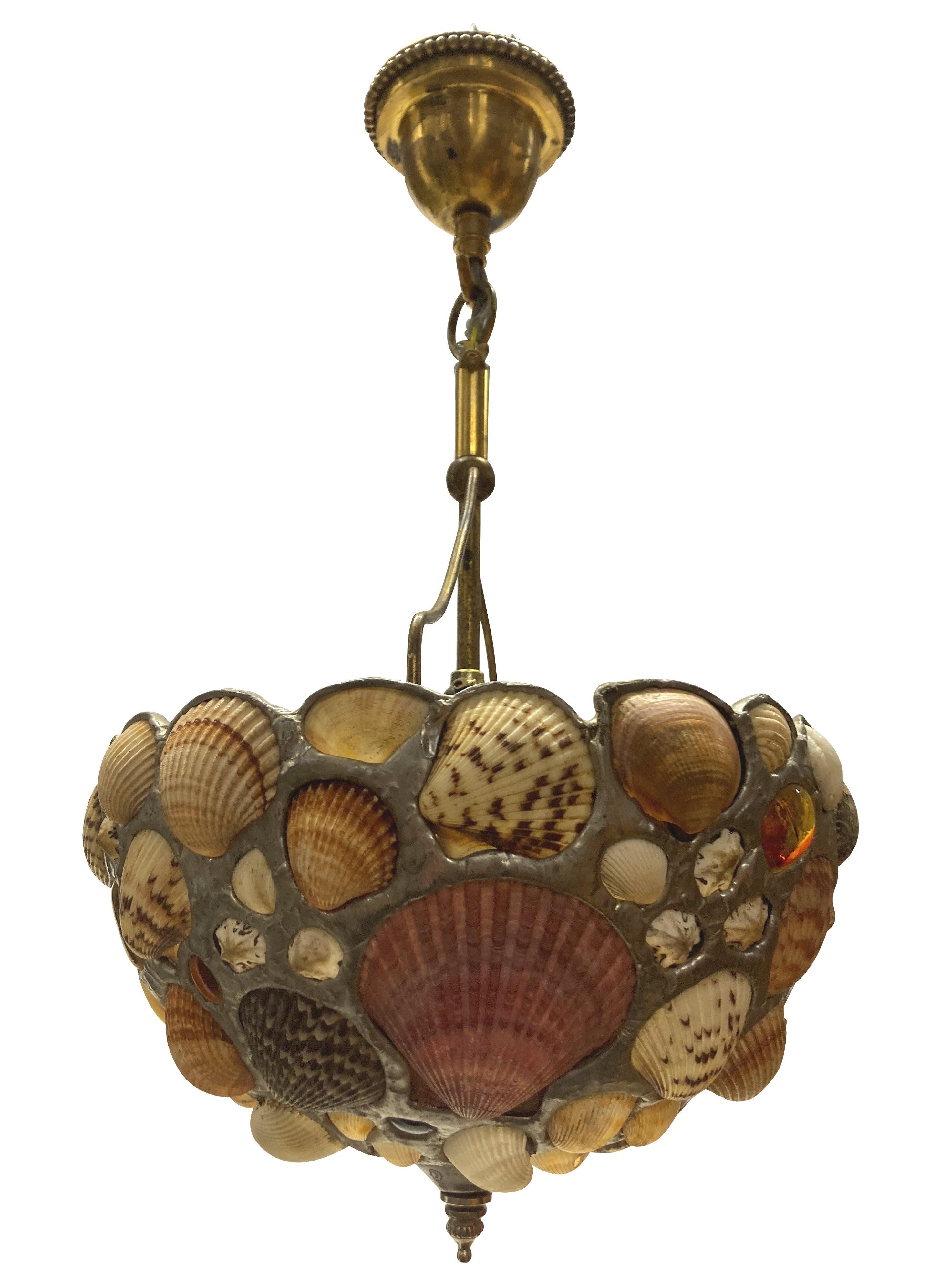 An American shell grotto pendant light, set with various sea shells and coloured beach glass. By Jose Produit studios.