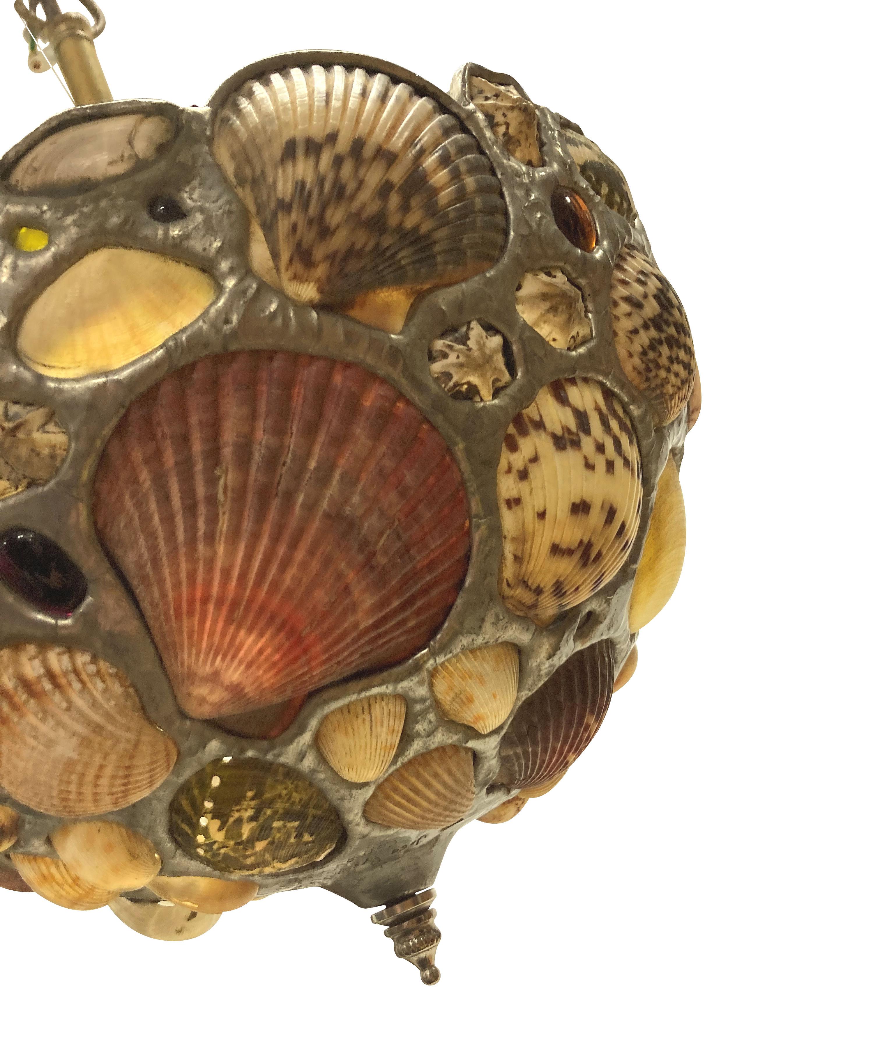 An American shell grotto pendant light, set with various sea shells and coloured beach glass. By Jose Produit studios.