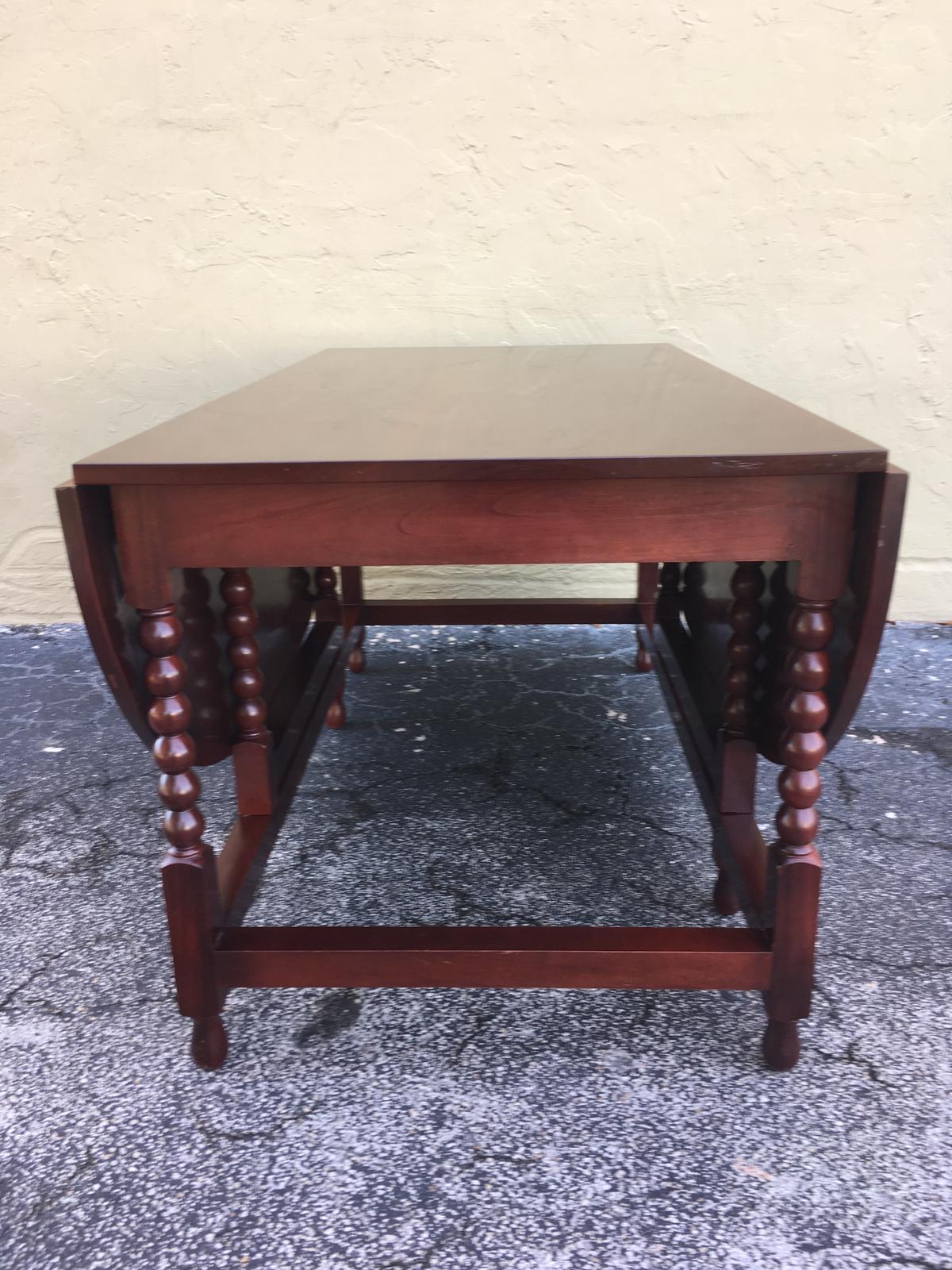 American Sheraton cherry table with a one board top, two scalloped drop leaves consisting of one board, interior supports, and terminating on acanthus carved legs, early 19th century
Measure: Table is 51.75 wide with leaves up and 24.25 wide with