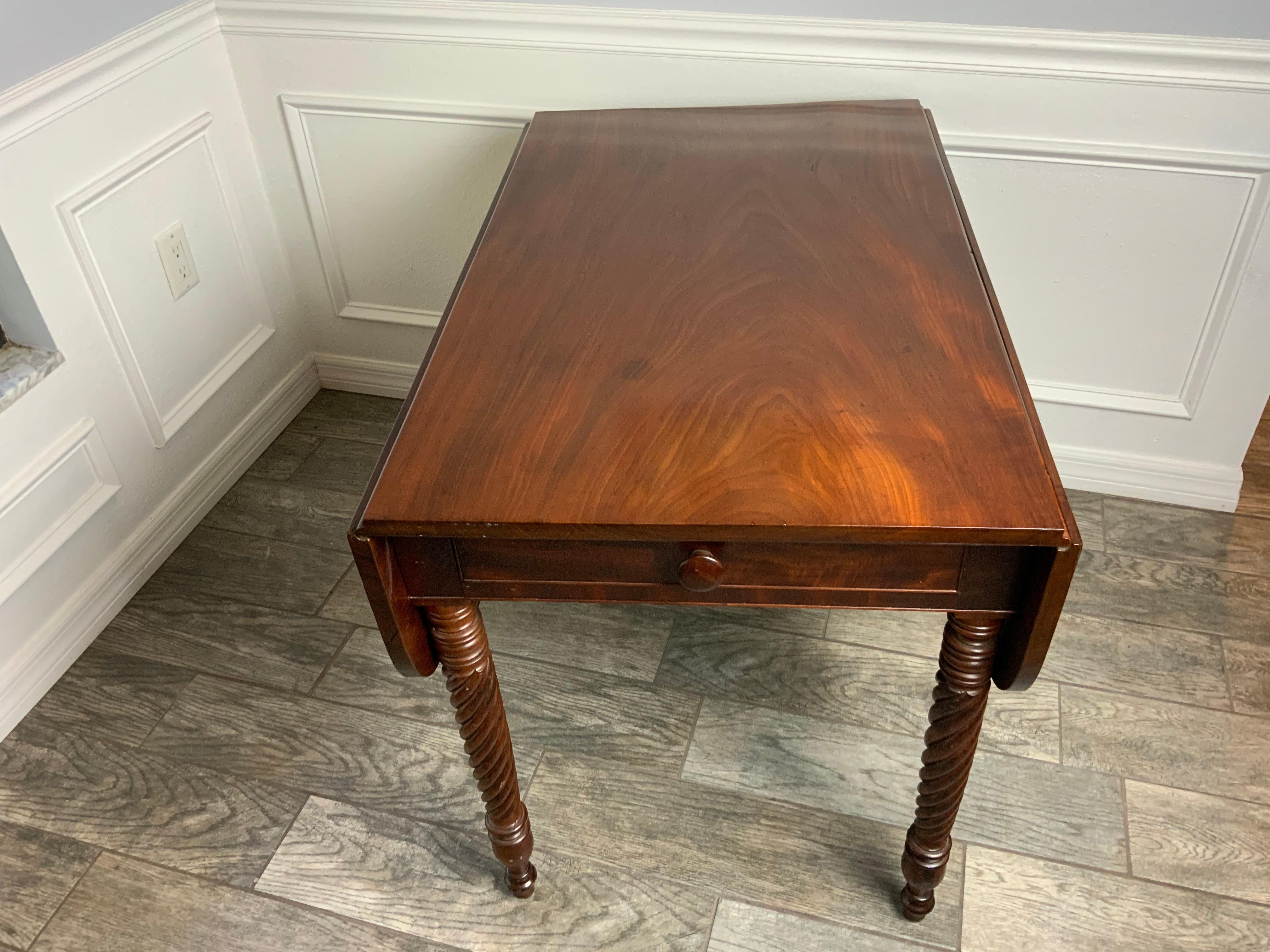 Exceptionally clean American Sheraton drop leaf table with rope twist carvings ending in nicely turned legs.  One board solid top and leaves that are also grain matched to the top.  Solid curly Maple swing out hinge supports on a white Pine apron.