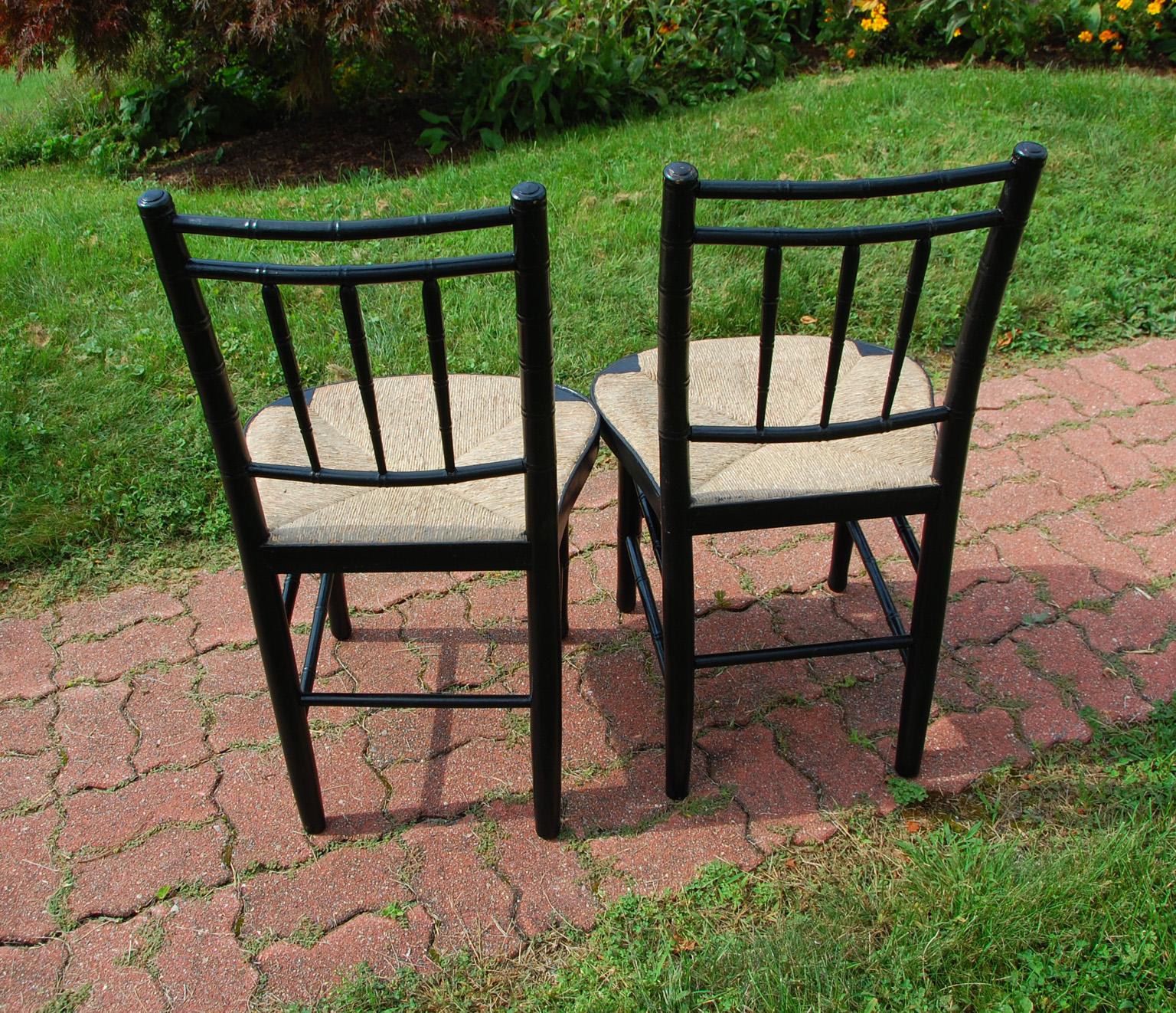 American Sheraton period pair of painted rush seated bamboo turned sidechairs. They retain their original rush seats, which are still in excellent condition. These chairs have lasted through time aided by their double box stretchers which add