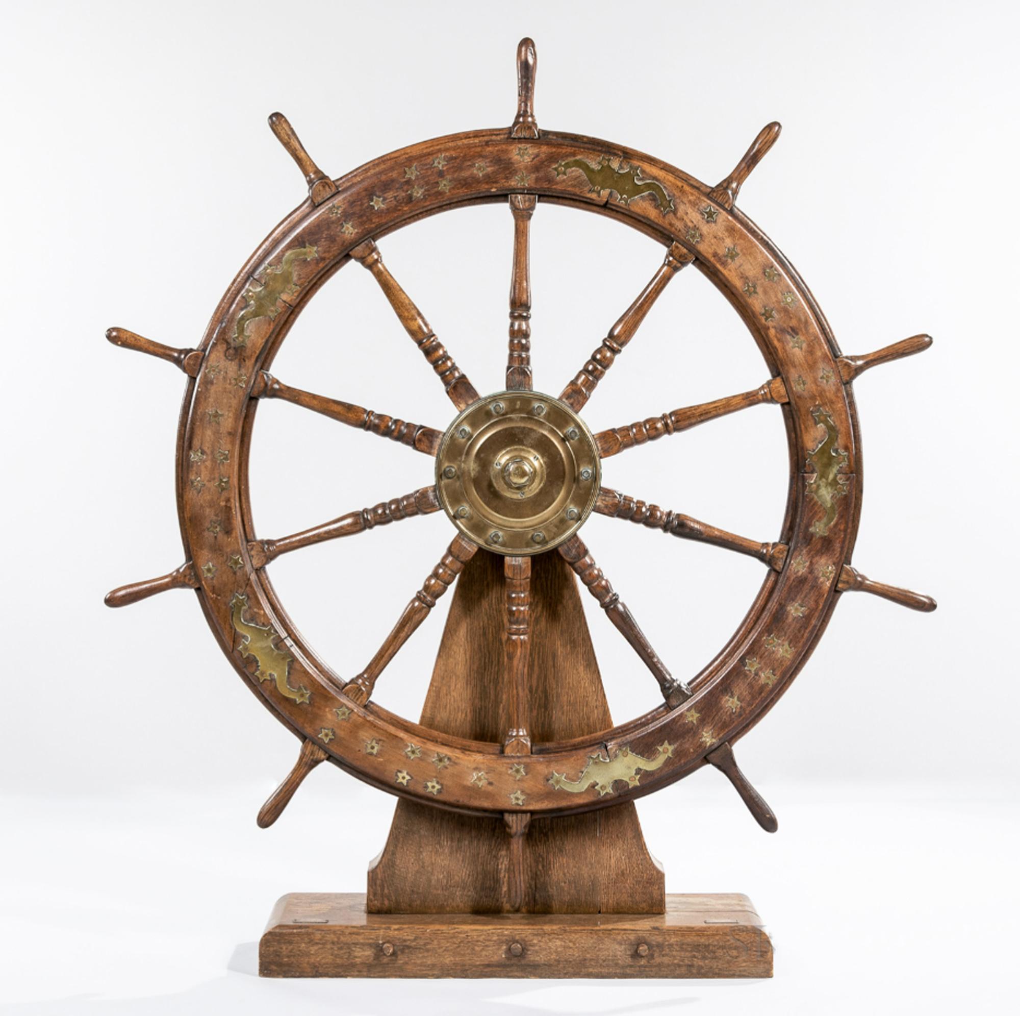 Ship's Helm with brass inlay of shooting stars and stars,
Early 20th Century

The large decorative ship's wheel or helm are beautifully inlaid on both sides with brass decoration consisting of star groupings and depictions of shooting stars. The
