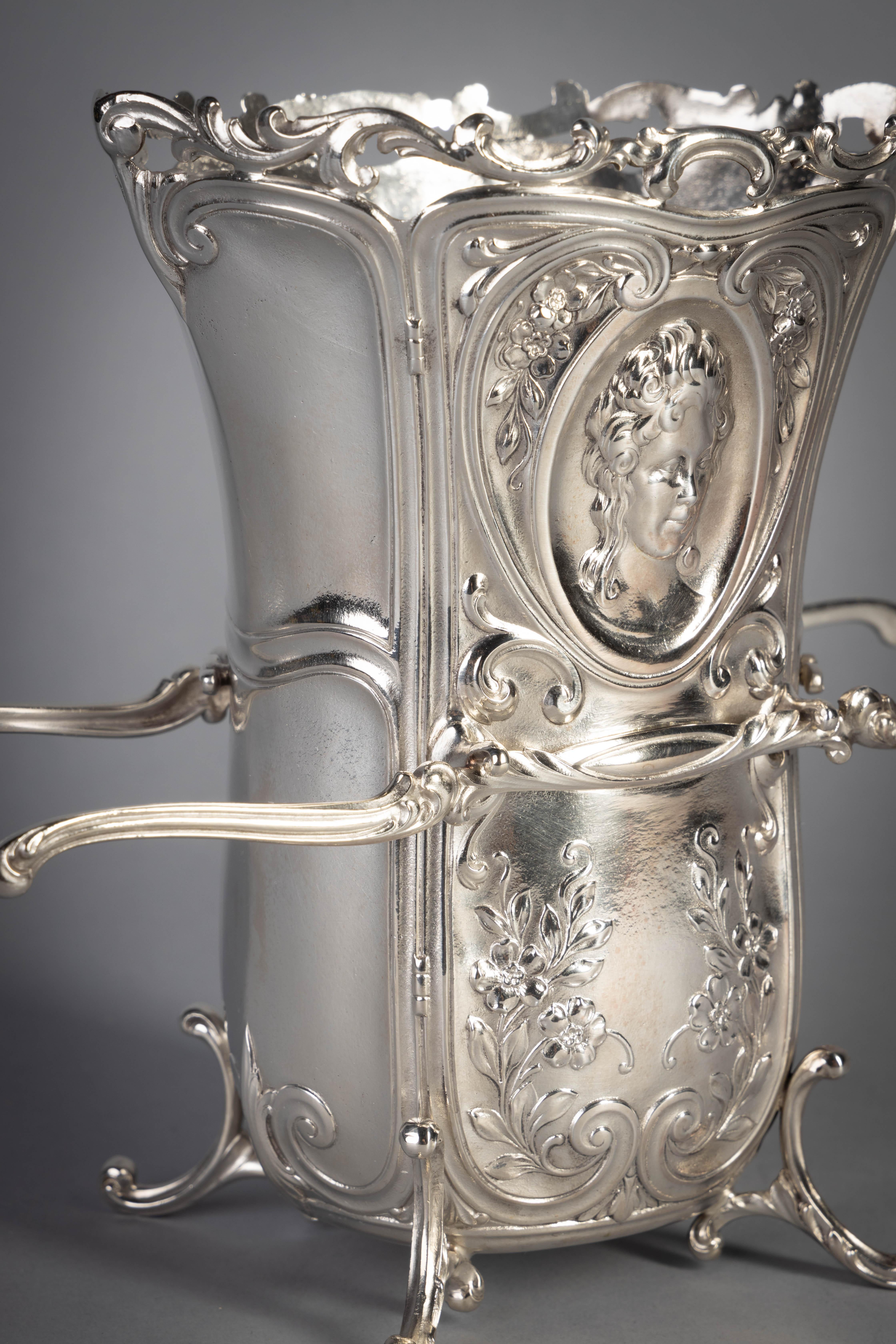 American silver sedan chair-form vase, Durgin Division of Gorham Mfg. Co., Providence, RI, 1931

The front and back cast and chased as doors decorated with floral sprays and oval windows enclosing the bust of a maiden, the sides applied with door