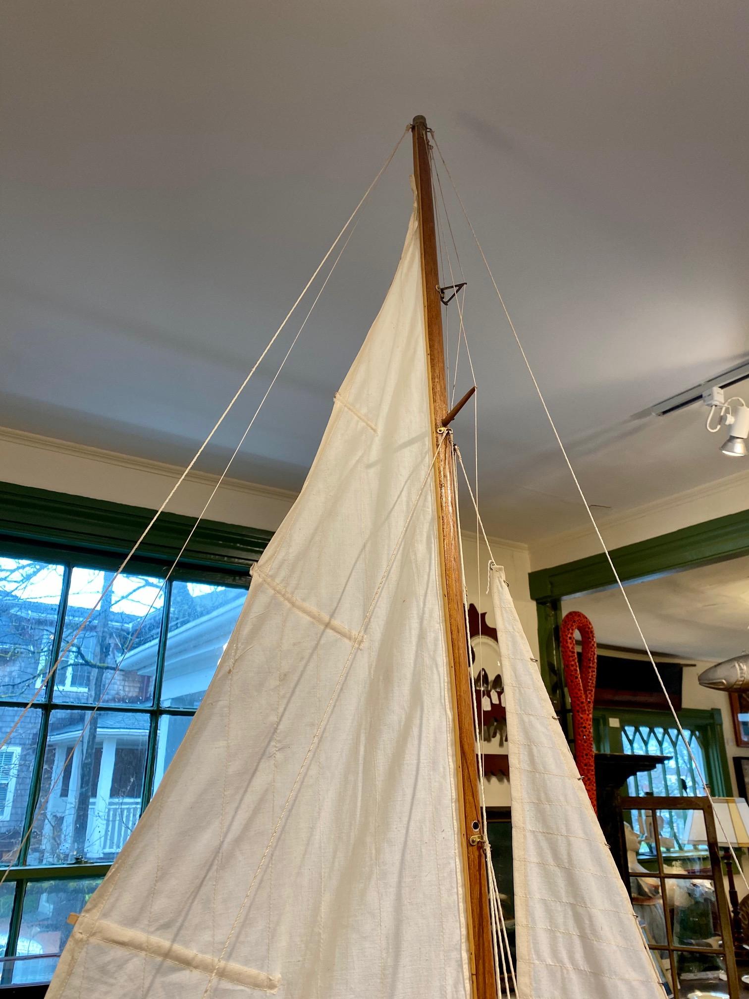 Antique American sloop rigged sailing pond model, circa 1900, having a high Marconi rig with double spreaders and full running rigging, on hollow hull with planked deck and lead keel. 

The vintage working rigging is not original but probably had