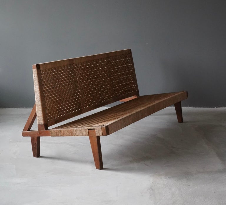 A sofa or bench. Walnut and original woven rattan / cane seat and back.

Other notable American designers of the era include Edward Wormley, Harvey Probber, T.H. Robsjohn Gibbings.






