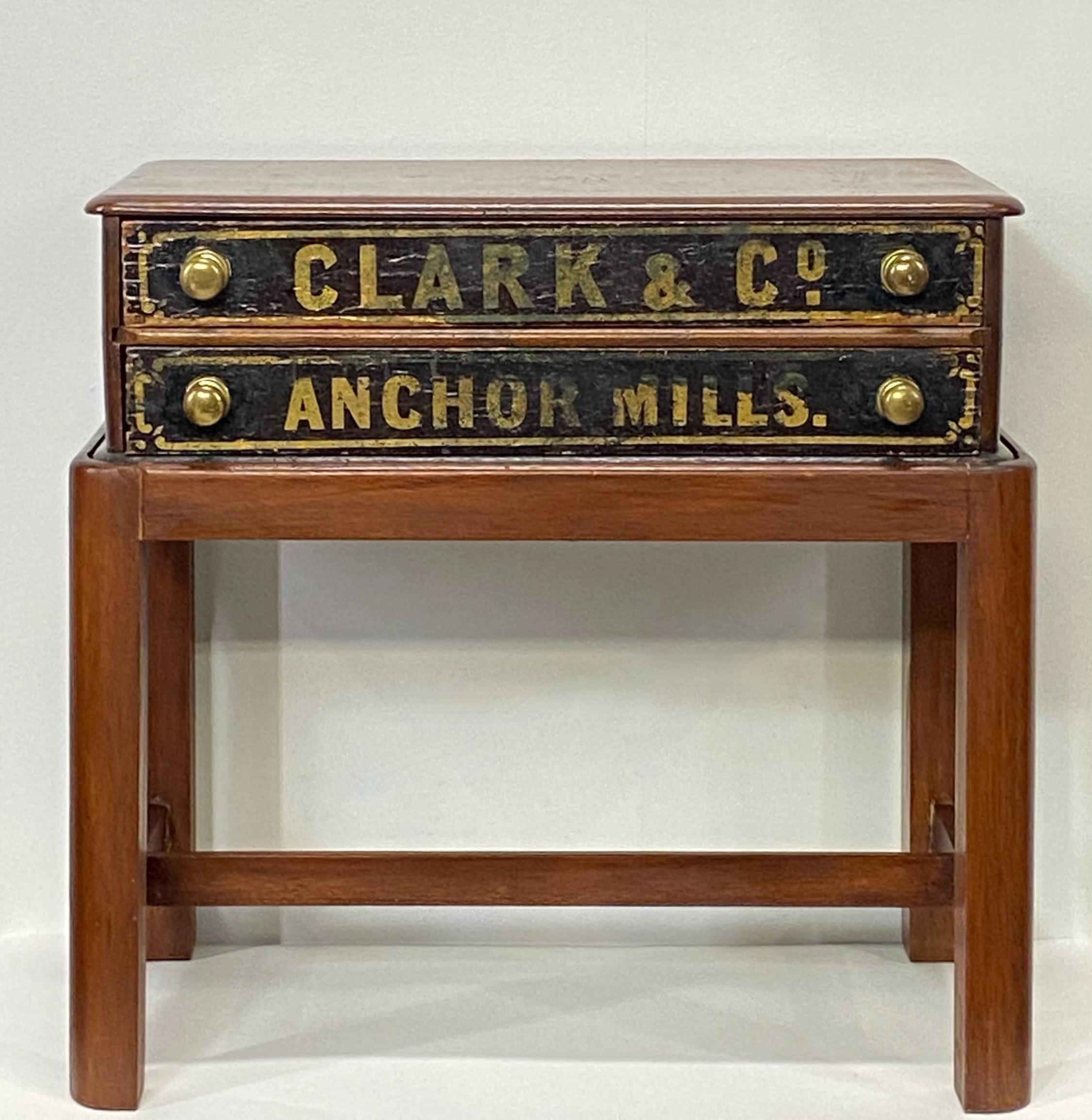 An antique clarks Thread Co. advertising walnut spool cabinet with gilt lettering, on later (1970's) custom made mahogany stand. Made to use as a side table.
American, late 19th century.

