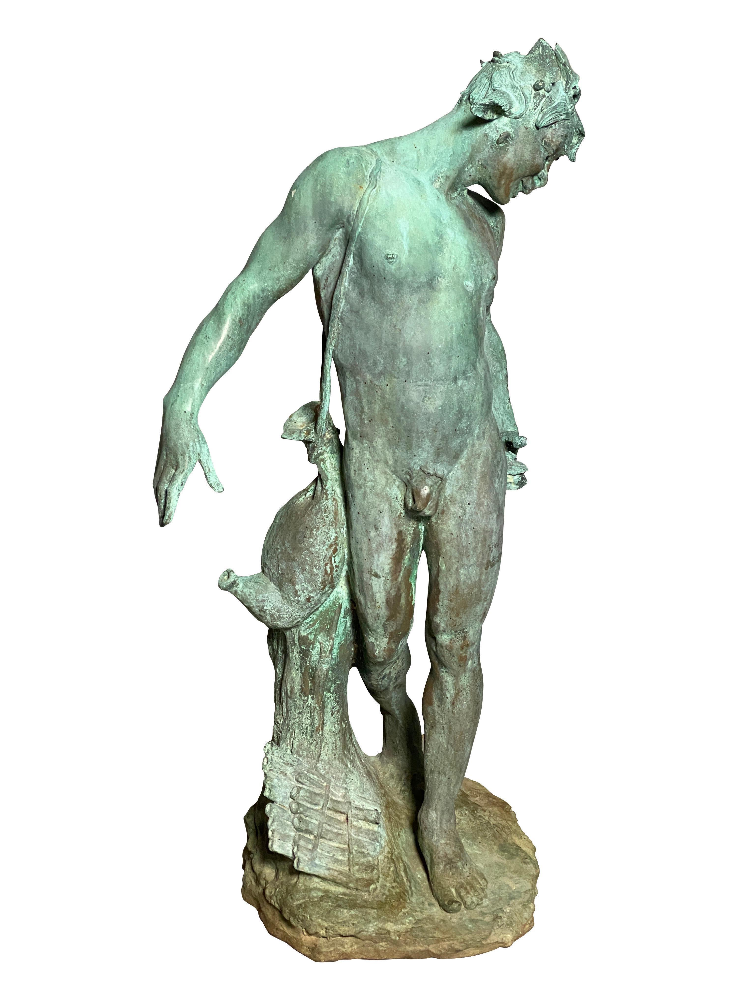 With vertigris patina, standing nude figure with a strap holding a wine flask. A flute at the base of his feet. Signed CBN and Roman Bronze Works.