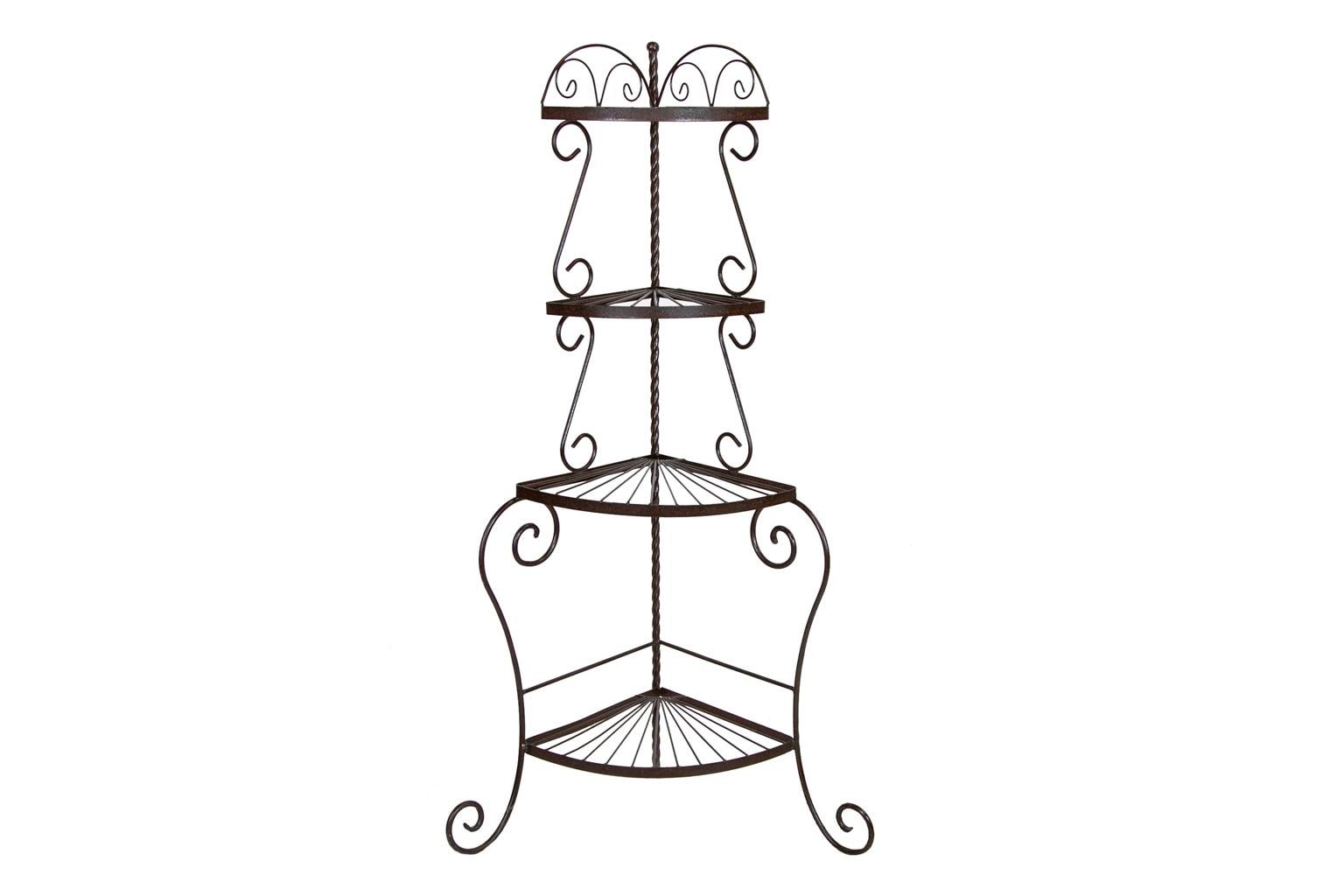 This steel corner stand shelf has four fan shaped shelves that are supported by scroll shaped supports. The rear corner pole has a spiral barley twist shape.
   
