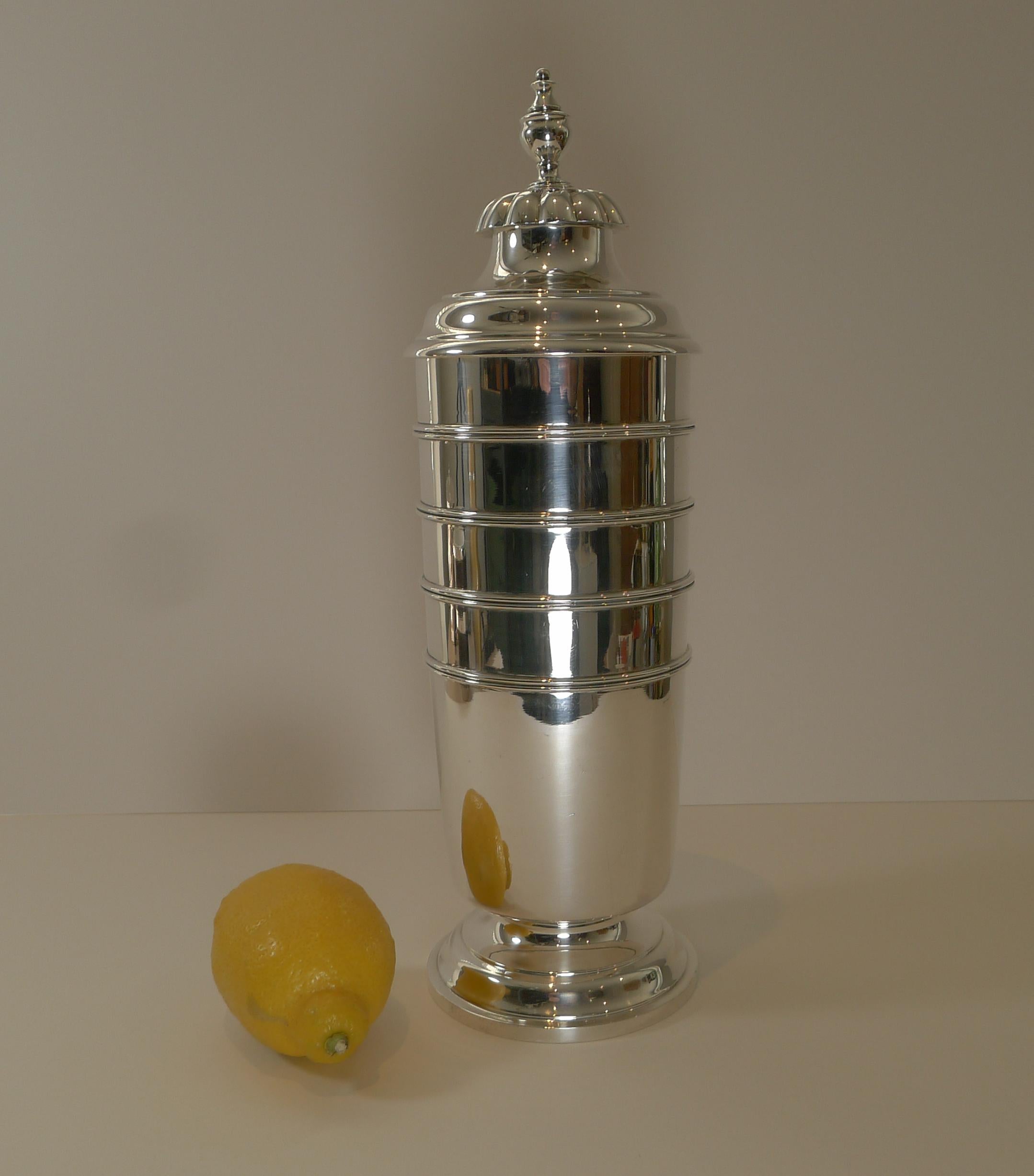 An absolutely stunning huge cocktail shaker in American sterling silver by the Boston silversmith, Tuttle. 

This towering example towers 14