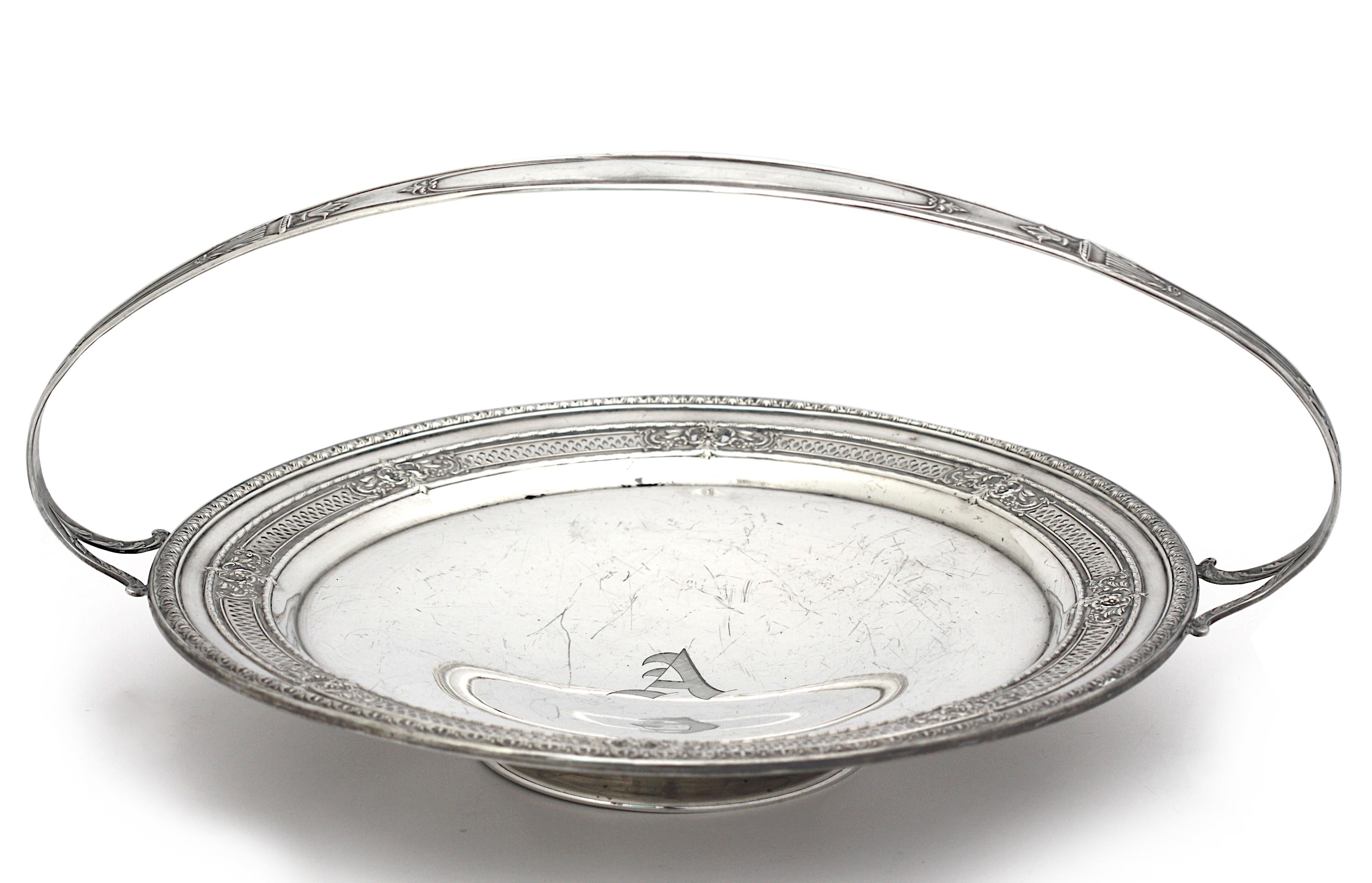 
American Sterling Silver Footed Dessert Basket
Marked International Sterling H15-1A. The pierced circular tray chased with flowerheads and leaf scrolls, with a loop handle and circular foot.
Height 6.75 in., Diameter 10 in., 14.7 troy oz.