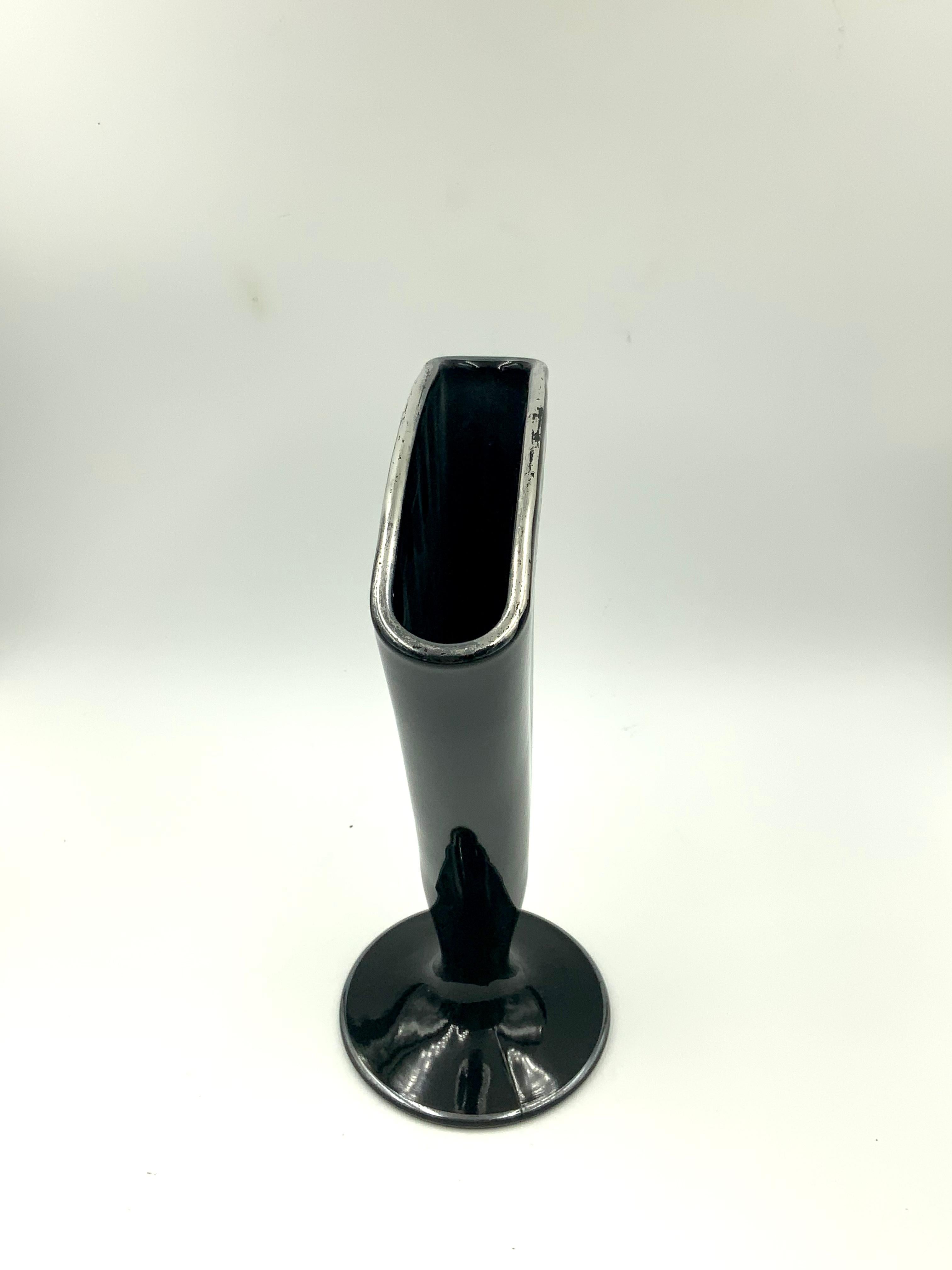 American sterling silver overlay black fan shaped vase featuring a foliate design on the top area of both sides. The boots edge and top edge also have a line of silver on the edge. Both sides are marked sterling in 2 places. A great vase for flowers