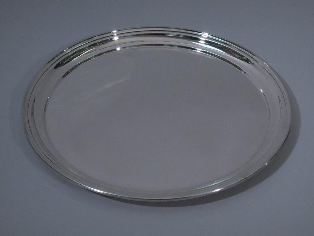 American sterling silver serving tray. Circular with molded rim. Elegant and serviceable. Hallmarked Ensko, a New York maker noted for reproducing Colonial silver. Number 714. Weight: 15 troy ounces.