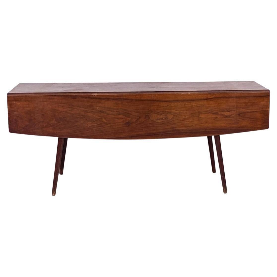 Wonderful American Studio craft solid walnut drop leaf dining table by Woodworker Walker weed with 4 tapered legs. Organic table design made in the style of Nakashima. All solid walnut with brass hardware great vintage condition. Leaves drop down on