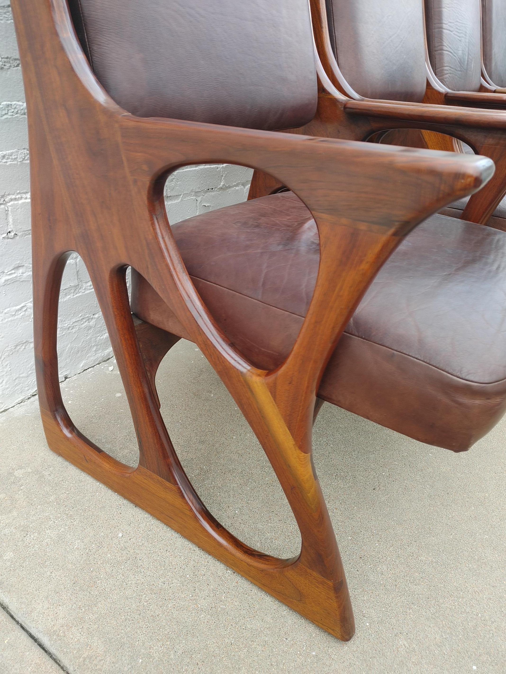 Beautifully crafted solid walnut American Studio Movement style dining chairs.  Very sculpturally unique and structurally sound seating.  Some expected wear on the leather seats with little wear on the walnut frames.  These would be rated above