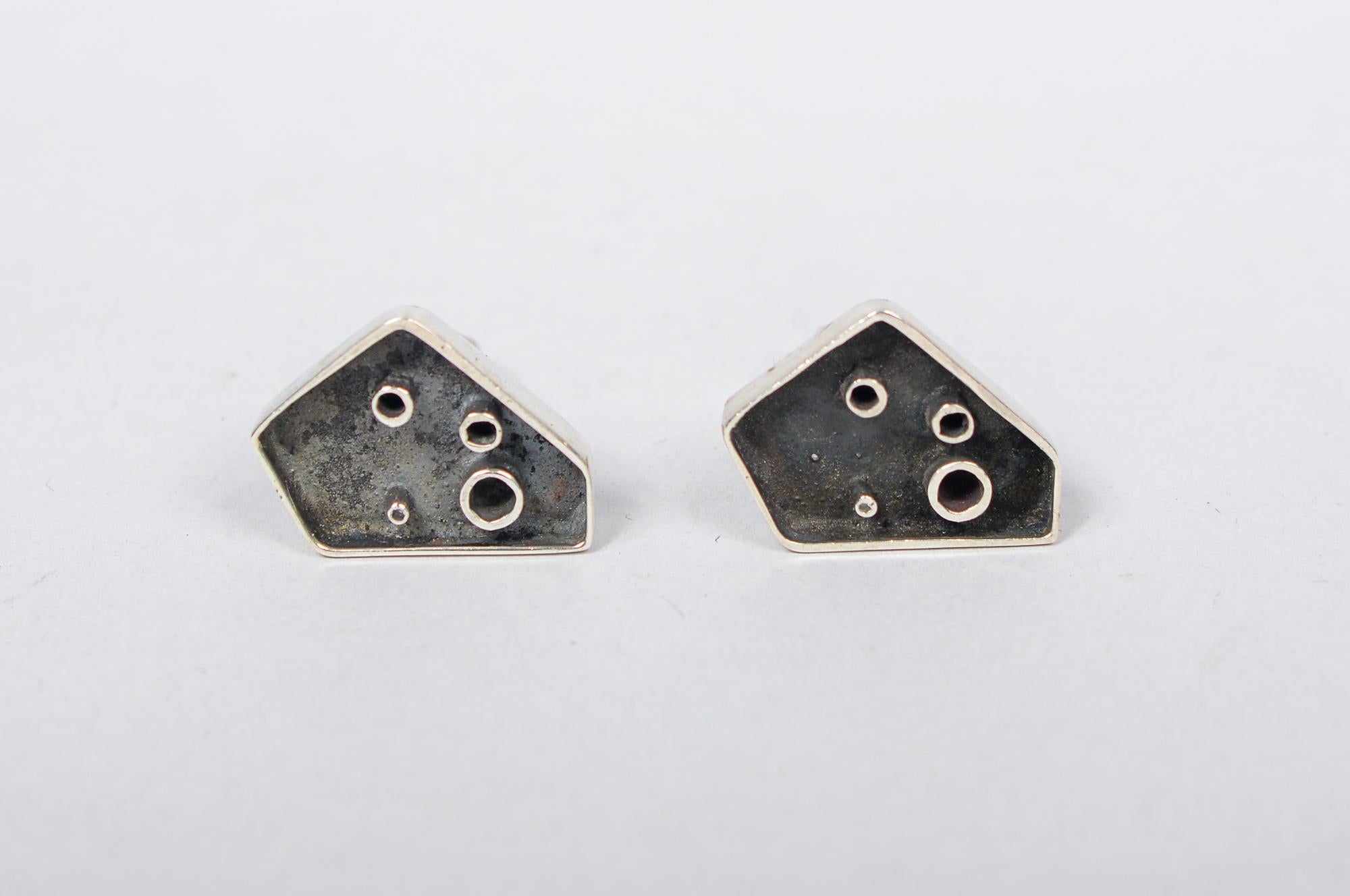 Pair of sterling studio craft modernist cufflinks. These do not have a makers mark. They do show the influence of Margaret DePatta. One has a some discoloration of the patinated portion.