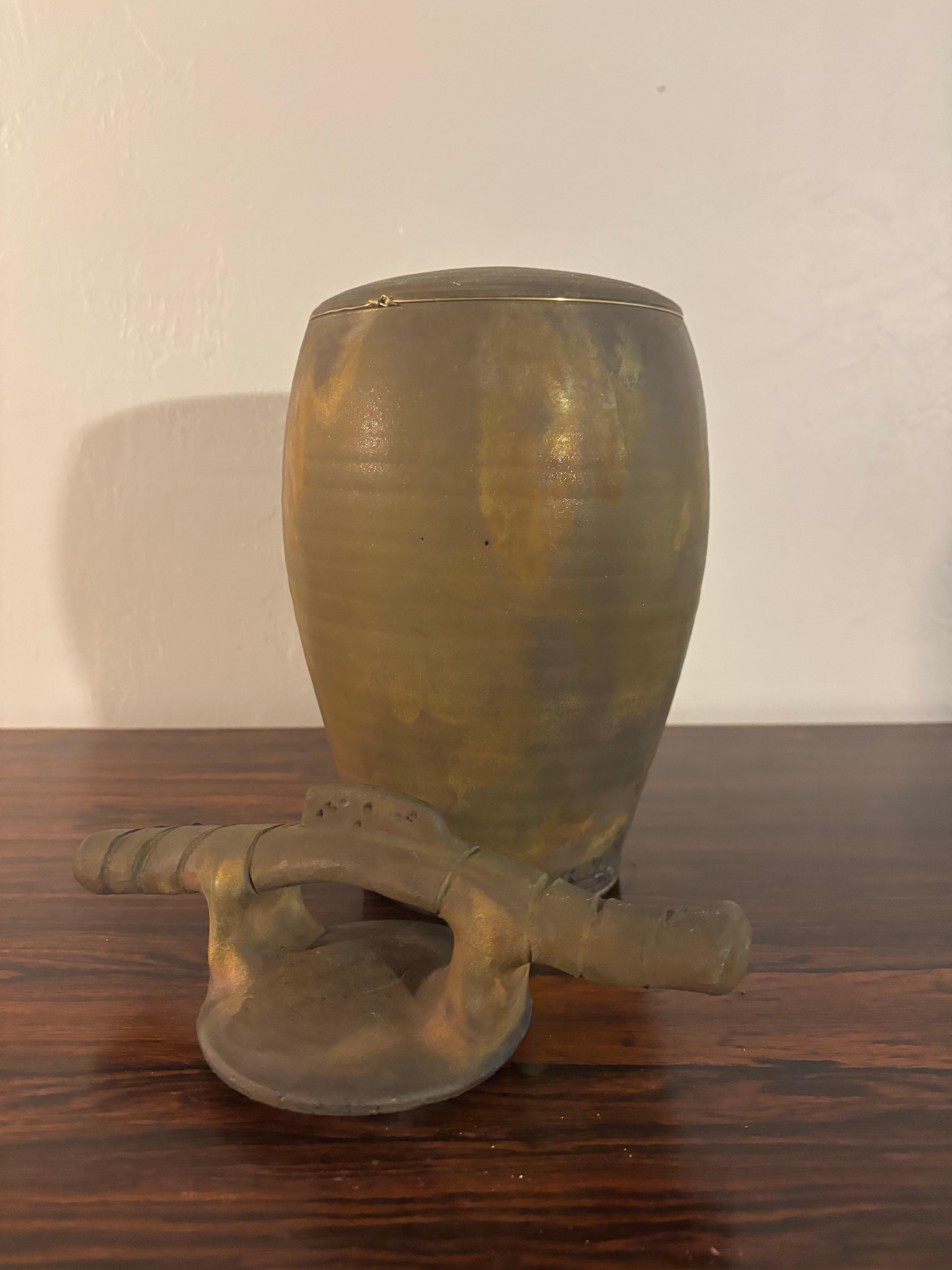 Beautiful copper flash Raku pottery. 

American studio ceramics. 

Made by Bruce Johnson. 

Vase with lid. 

13” tall
6.5” deep
6.5” wide