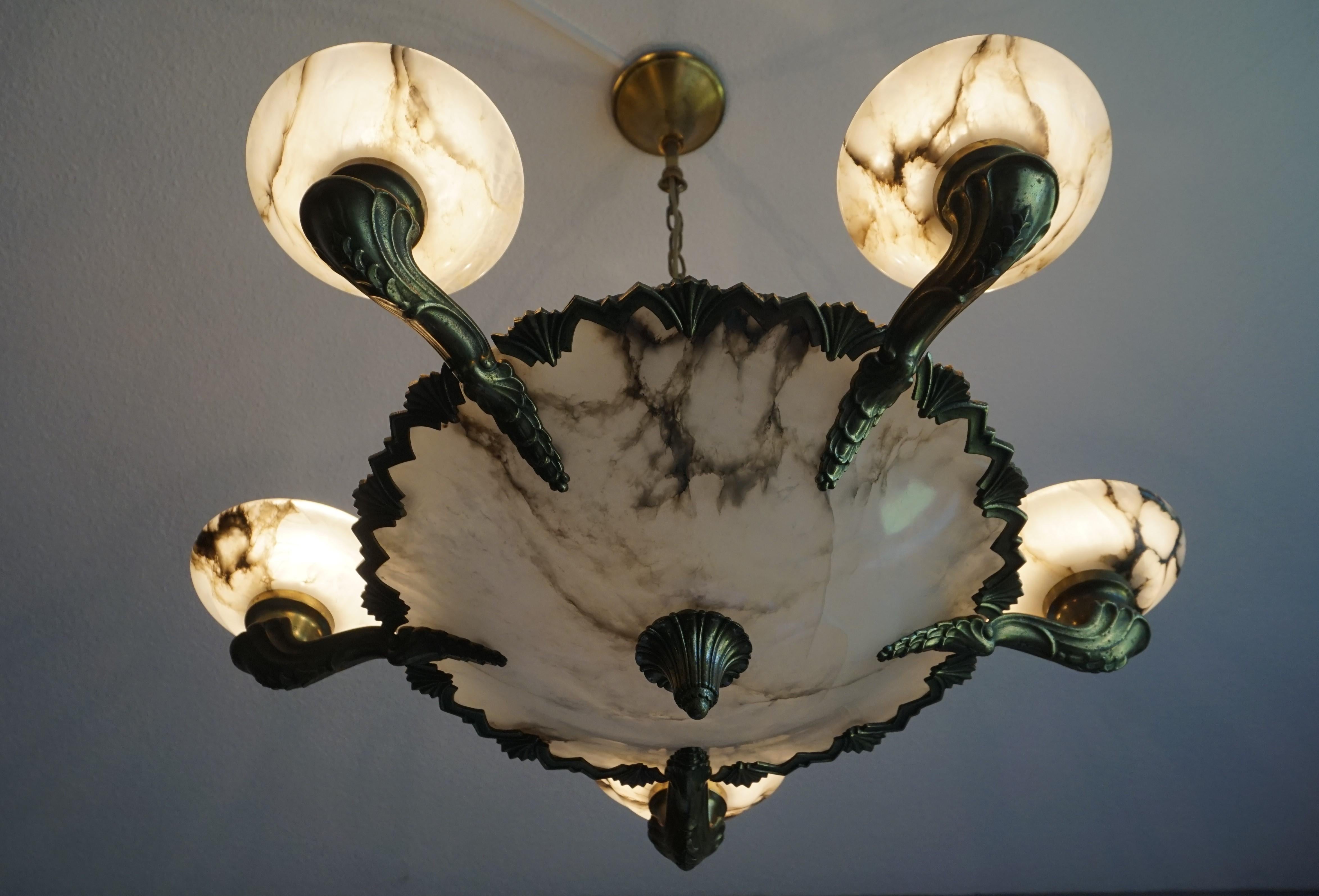 Striking and exclusive 1920s light fixture for the perfect atmosphere.

If you are looking for a remarkable light fixture to grace your living space then this American Art Deco Style chandelier from circa 1920 could very well be perfect. The