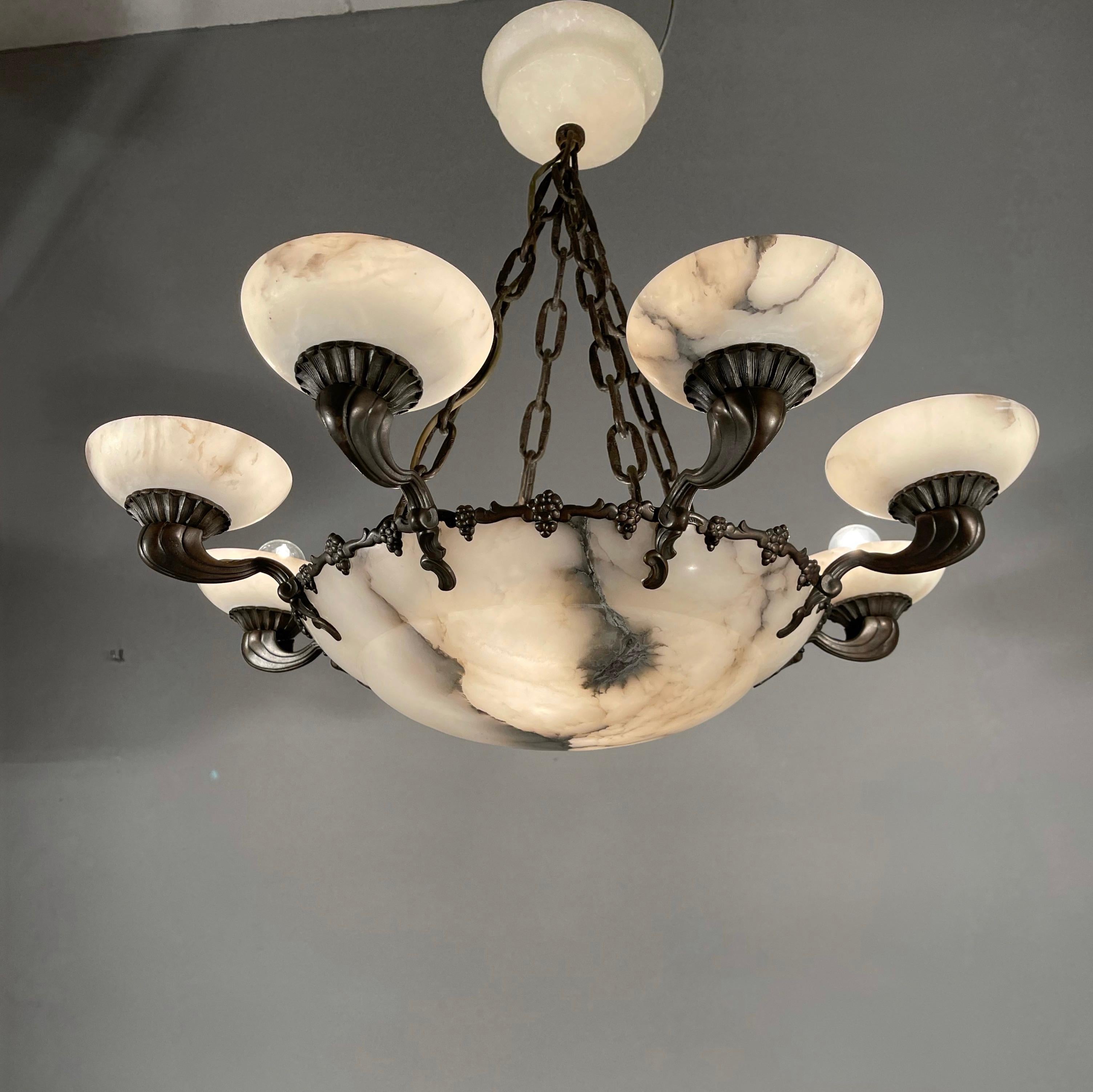 Striking and exclusive 1920s light fixture for the perfect atmosphere.

If you are looking for a remarkable light fixture to grace your living space then this American Art Deco style chandelier from circa 1920 could very well be perfect. The