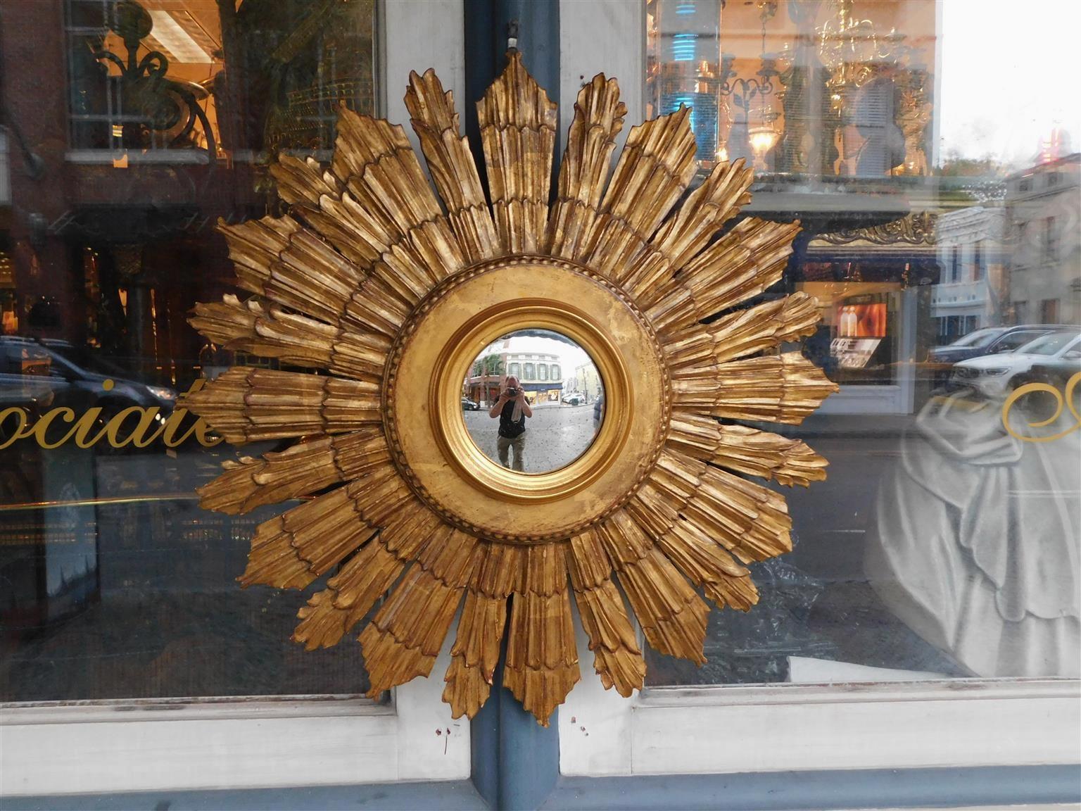American Sunburst gilt carved wood and gesso bullseye wall mirror with interior beaded and molded edge rim. Mirror retains the original convex glass and backing. Late 19th Century.