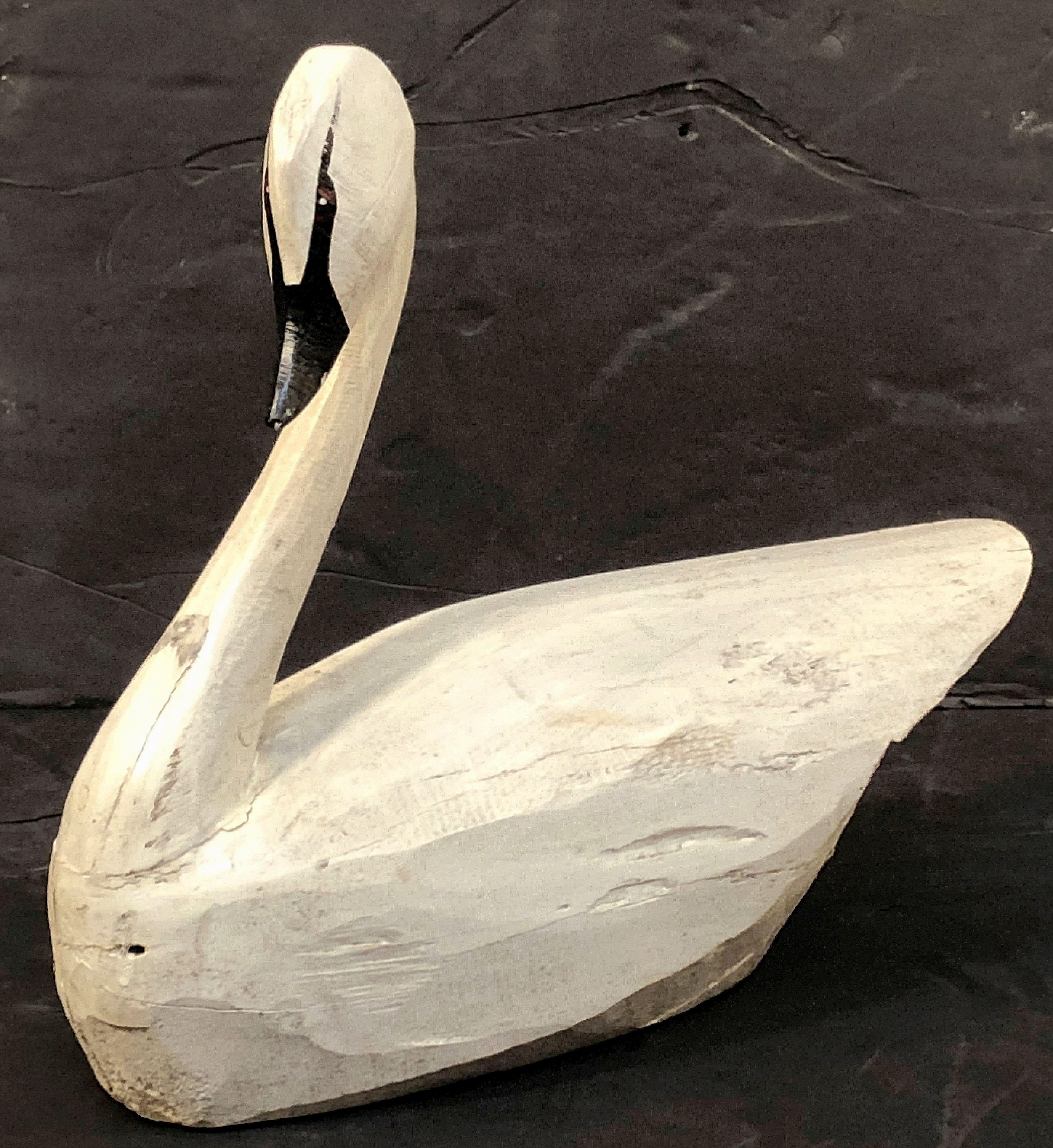 A fine American confidence decoy or sculpture of a swan featuring a carved and painted wooden head and body.

A great example of American folk art - graceful lines and handsome design.