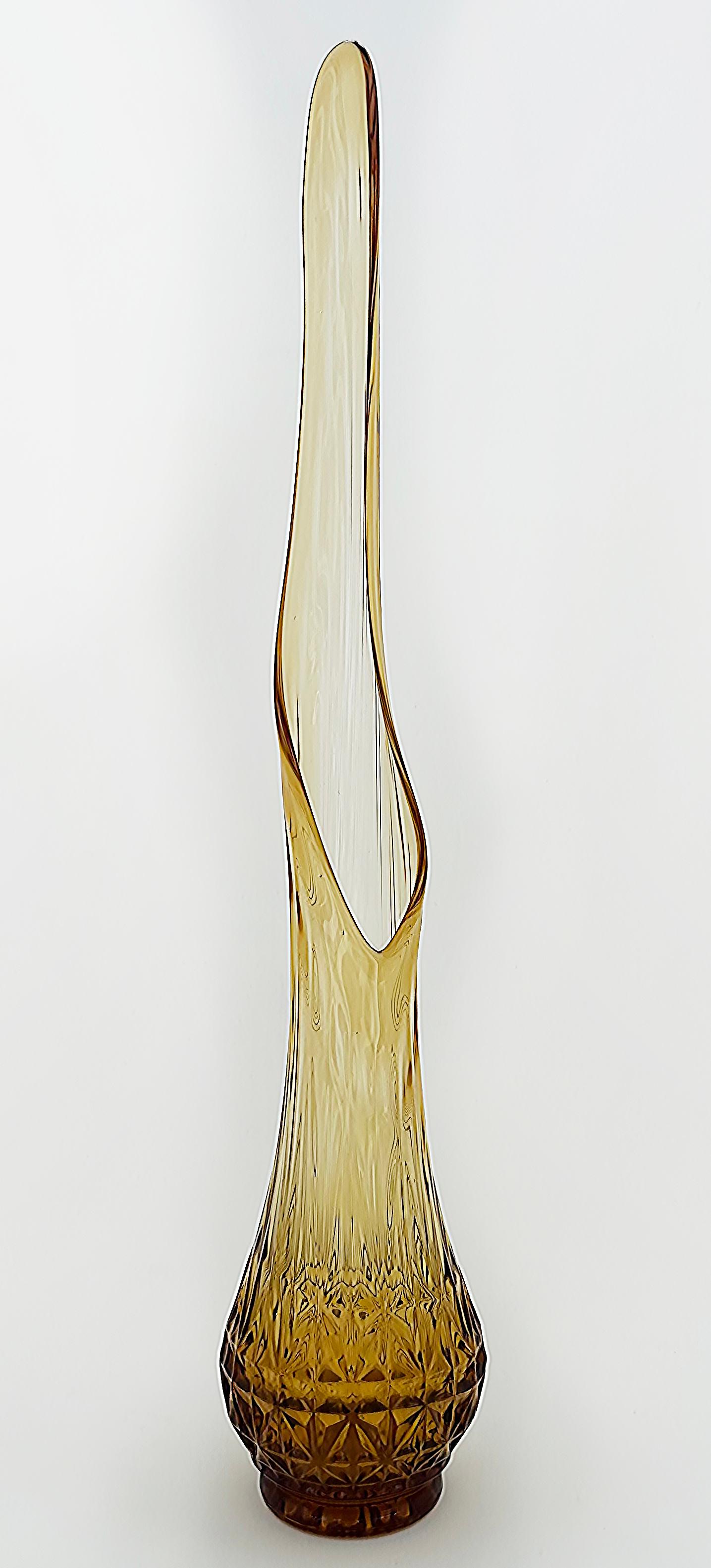 American Swung Glass Clear to Amber Tall Glass Vase, 1960s from New York Estate

Offered for sale is a circa 1965 amber glass vase that is blown into a mold and then pulled or stretched to form an elongated iconic vase design from the the '60s.