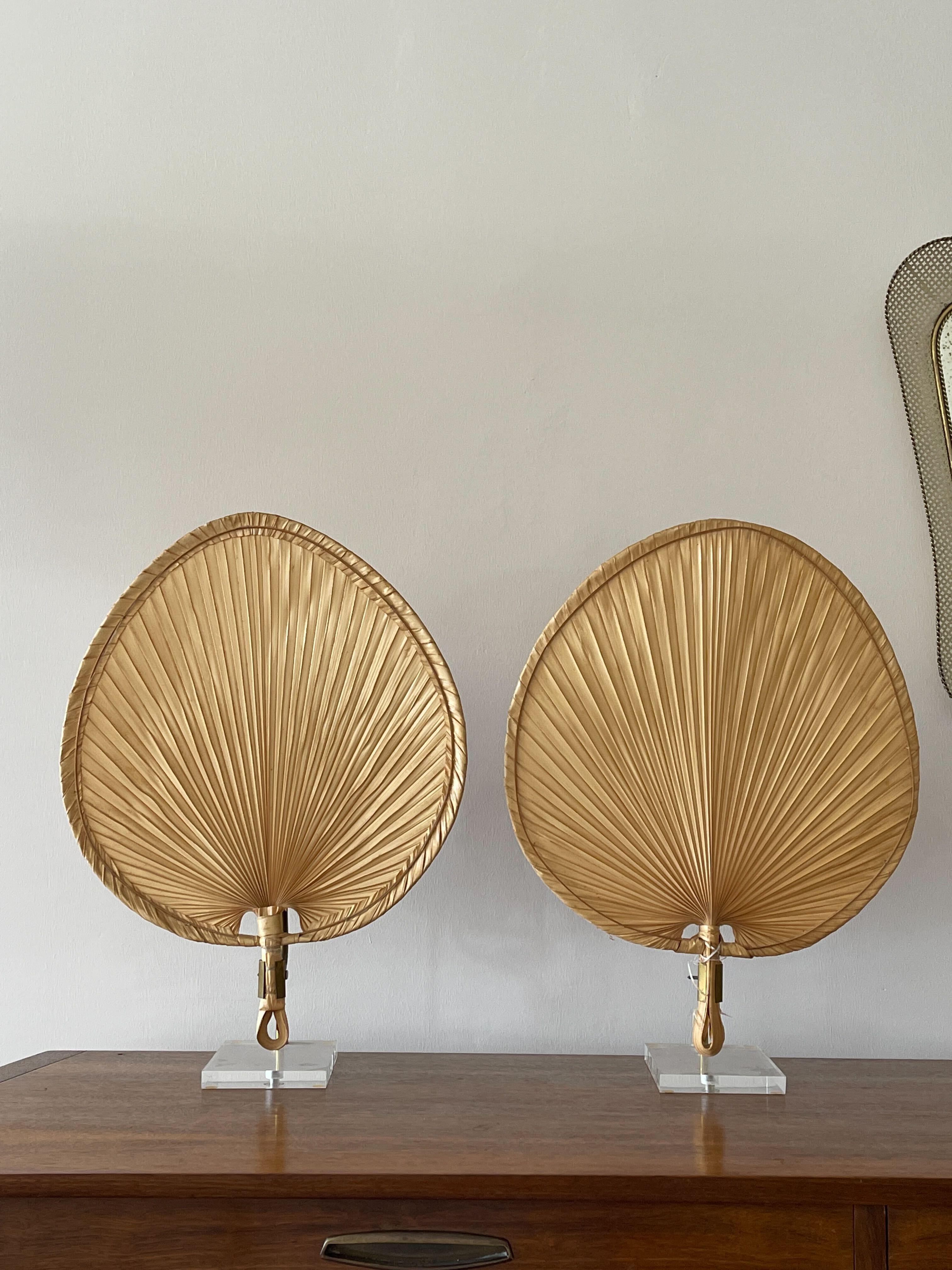 A pair of table lamps in the shape of a Japanese fan, bearing resemblance to Ingo Maurers famous 