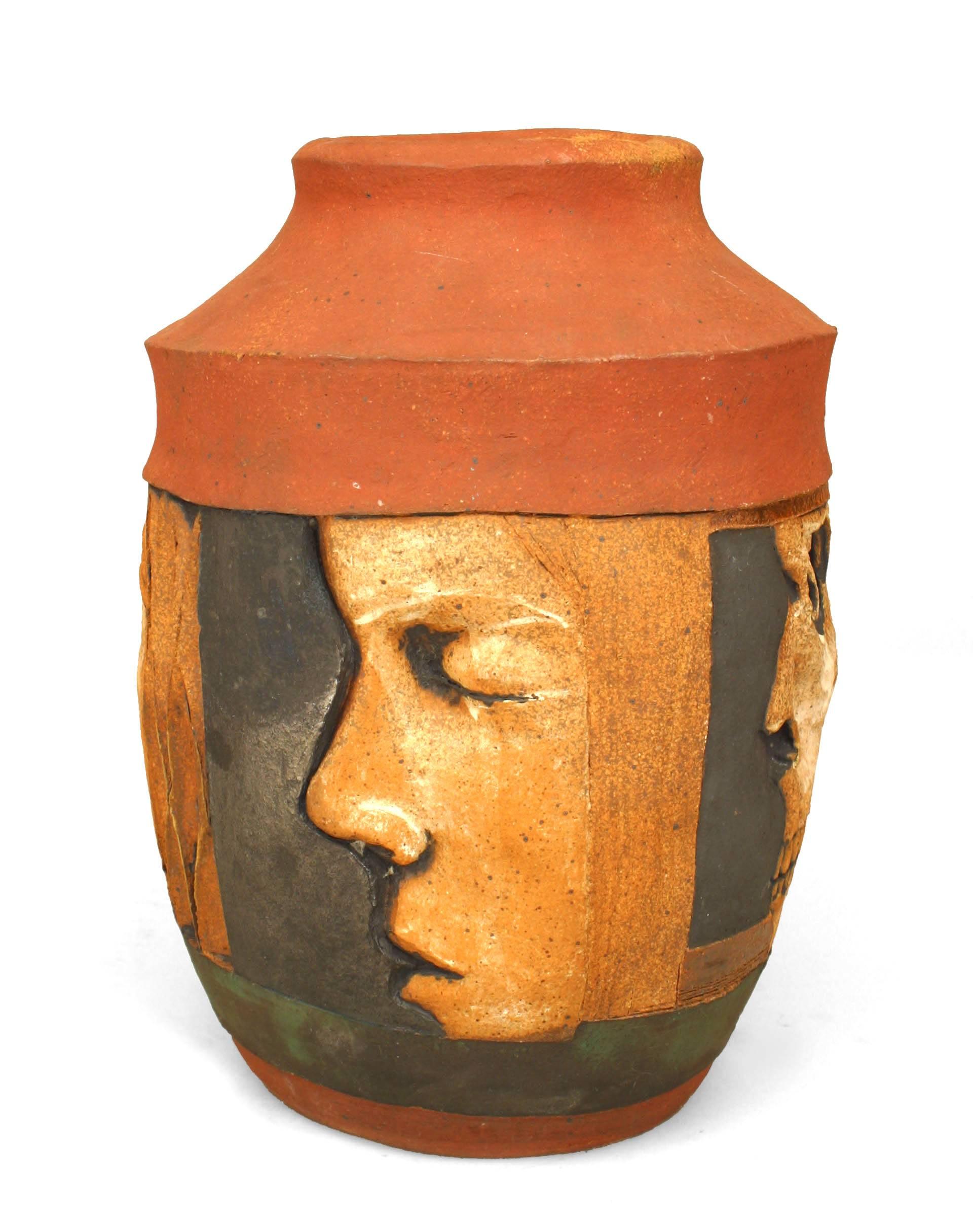 American Post-War Design terra cotta and black trimmed vase with 4 profiles of faces in relief. (by ROBERT BENTLEY)
