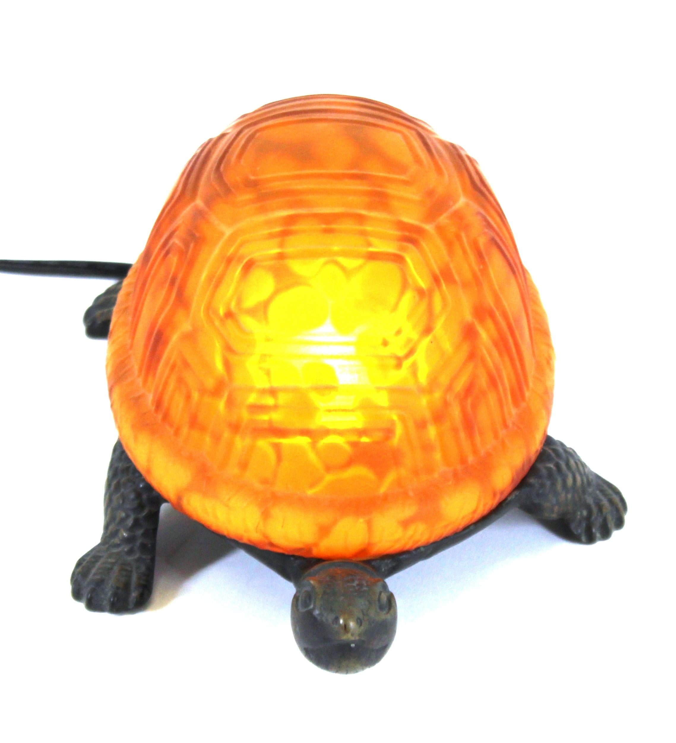 American diminutive bronze and art glass turtle table lamp or desk lamp. Made in circa 1930. The piece is marked 'TC' on the bottom. In great vintage condition with age-appropriate wear.