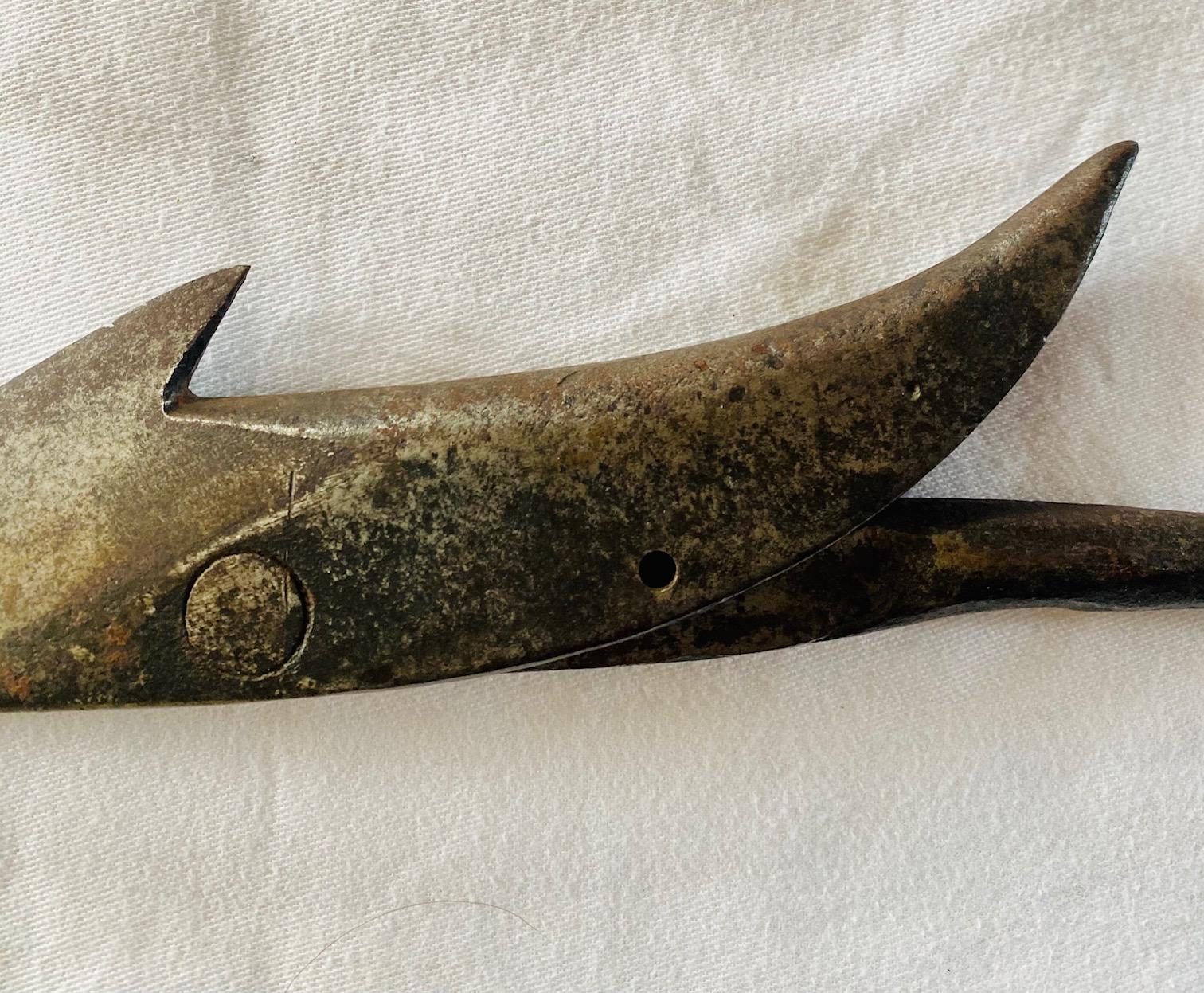 Antique American improved toggle iron harpoon, circa 1850s, having a 7-1/4 inch long toggle head with acute barbed cutting edge and up-swept rear barb, pivoting on flatted boss, on 3/8 inch diameter shank ending in socket with open seam. The socket