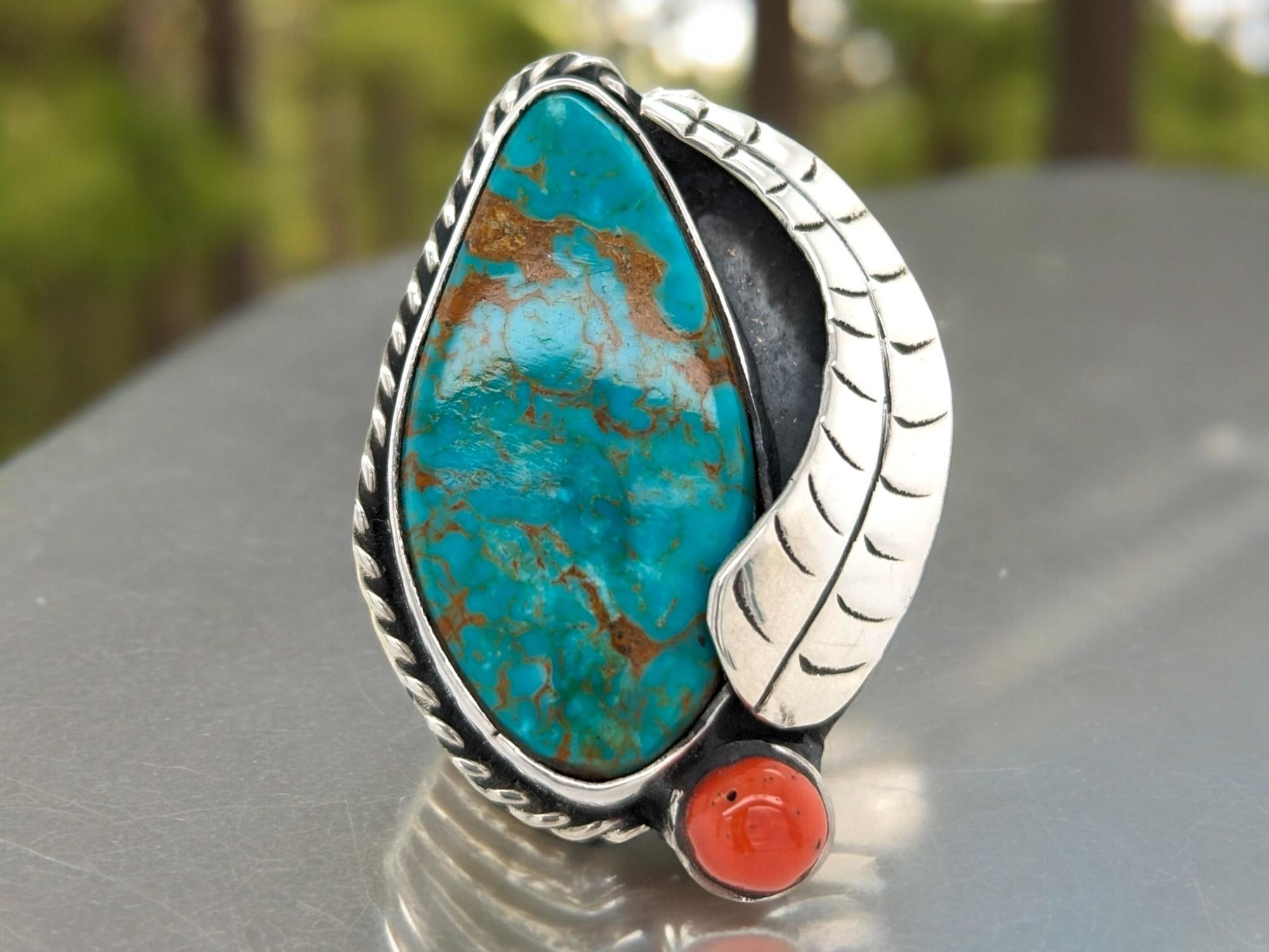 Embrace the vibrancy of nature with this stunning Turquoise & Red Coral Ring. Handcrafted in gleaming silver, this ring features a captivating combination of genuine turquoise and fiery red coral gemstones.

Unique Gemstone Pairing: The contrasting