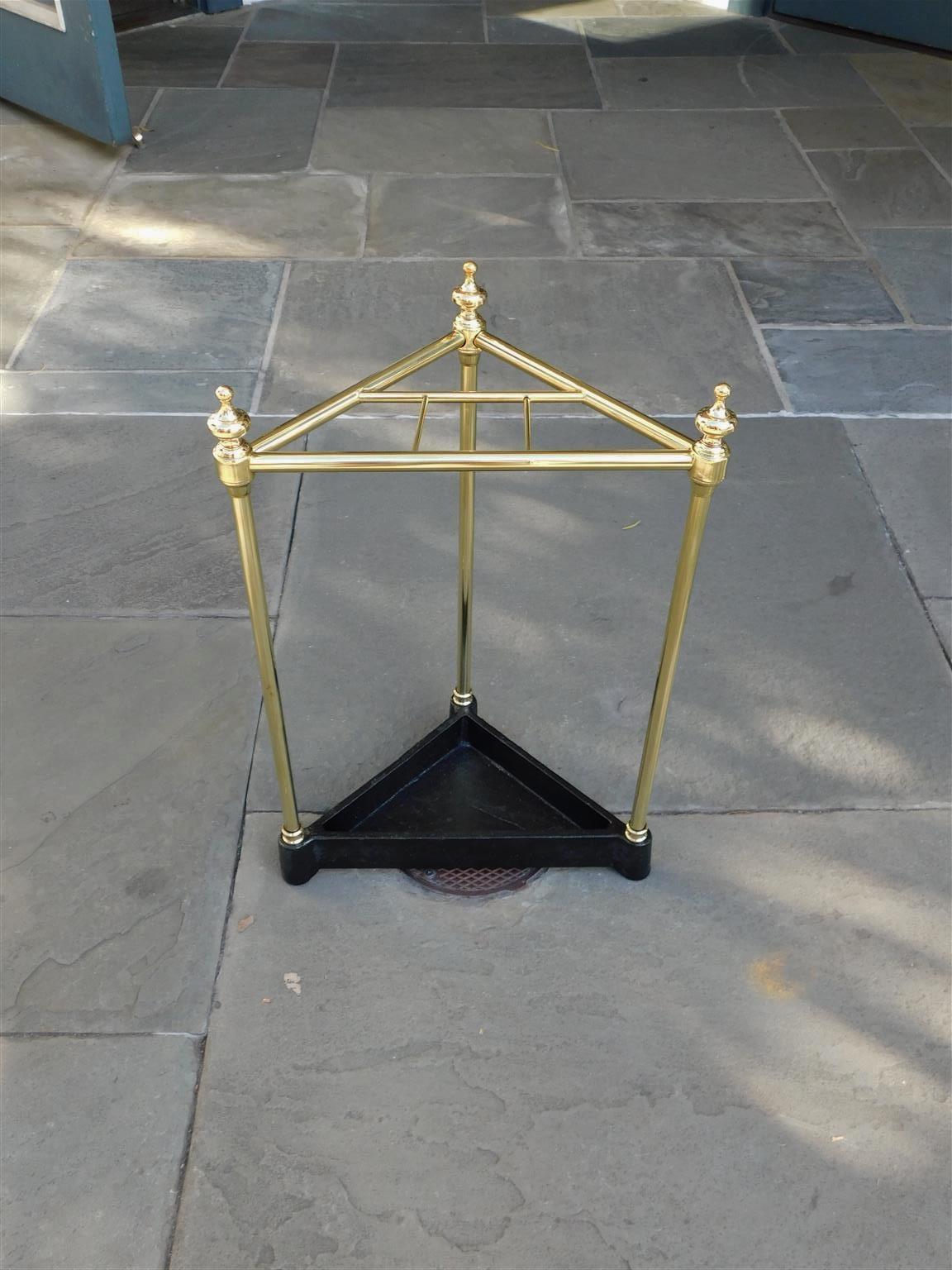 American Triangular brass and painted cast iron urn finial four slotted umbrella stand, Late 19th Century.