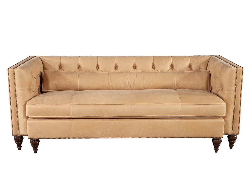 American Tufted tan leather sofa. Newly made by Baker Furniture in North Carolina, USA. This traditional design has been modernized with beautiful soft to the touch tan leather material with contrasting head-to-head antiqued brass nail heads.