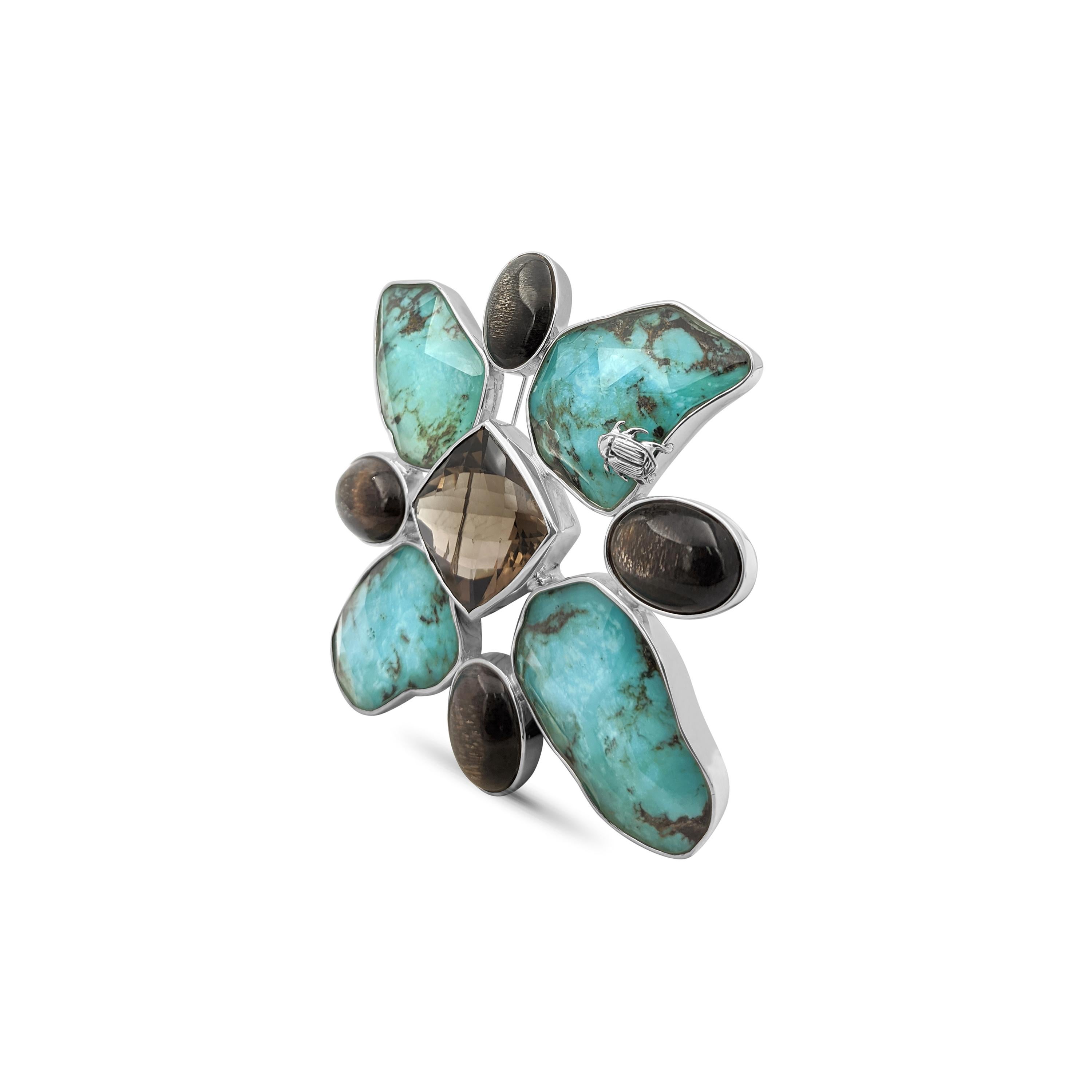 • Stephen Dweck One of a Kind of Stephen Collection  
• 925 Sterling Silver
• 3.5” X 3.5”

Behold the breathtaking beauty of Stephen Dweck's latest masterpiece, the One of A Kind American Turquoise Natural Quartz Sunstone Smoky Quartz Maltes Pin in