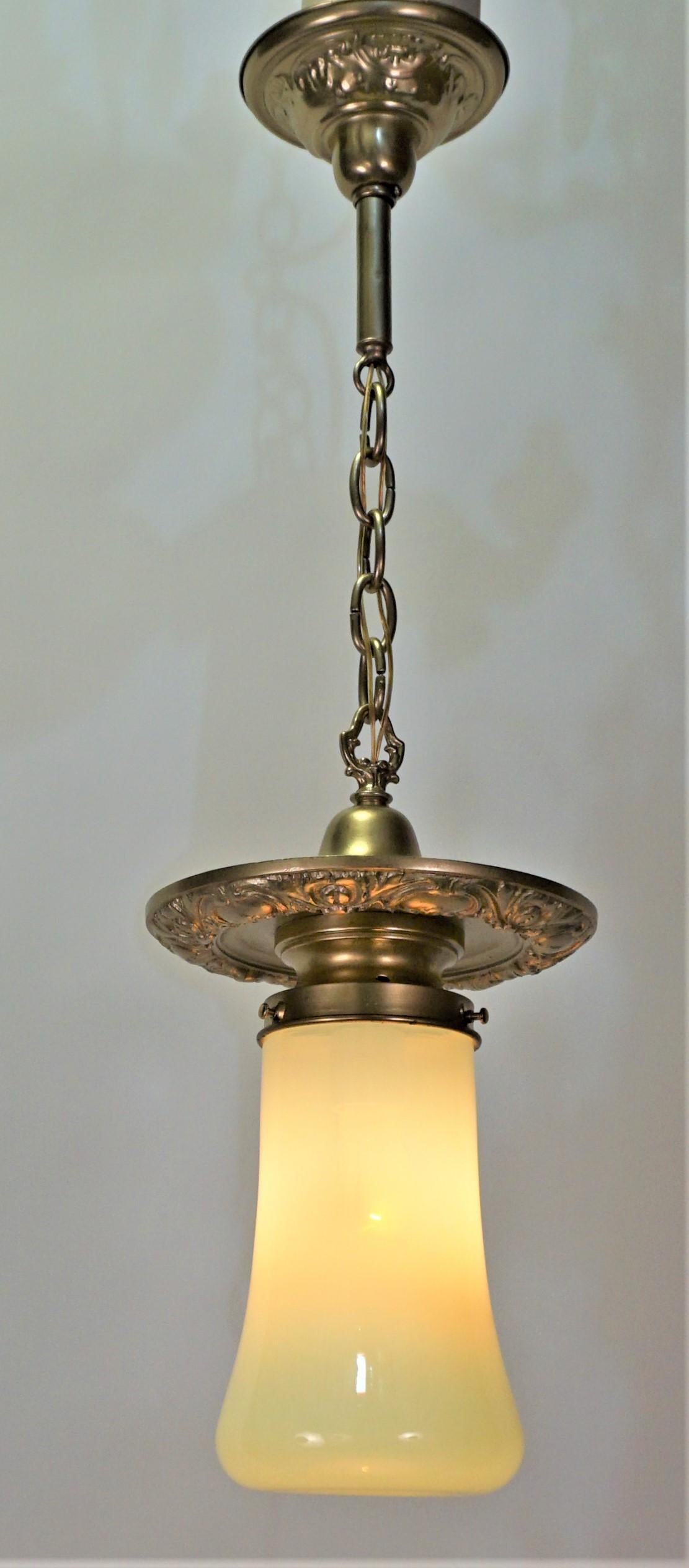 American brass chandelier with opaline-vaseline glass pendant or chandelier. 
Glass measurement: 9