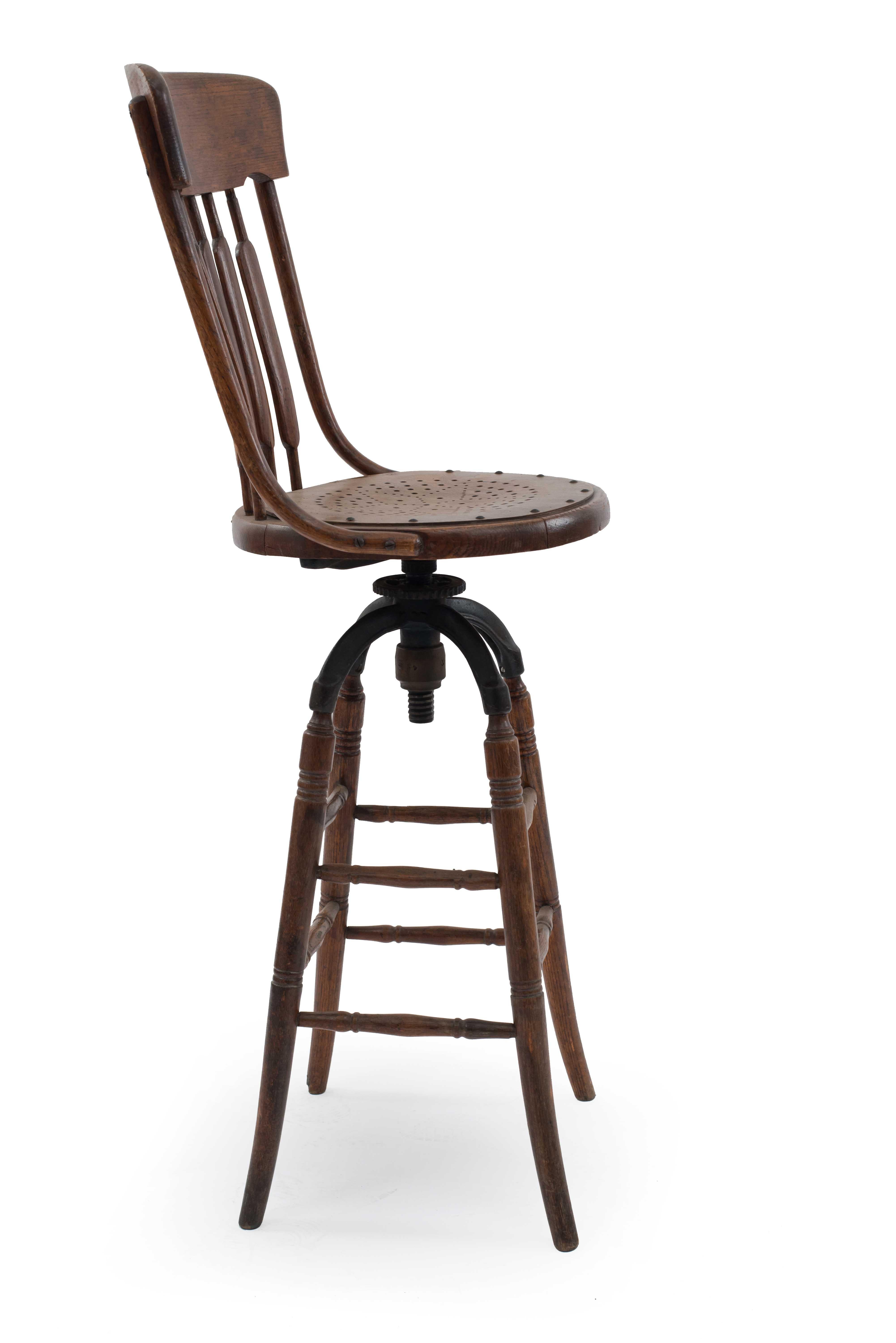 American Victorian oak bookkeepers chair with swivel and pierced seat and spindle back.