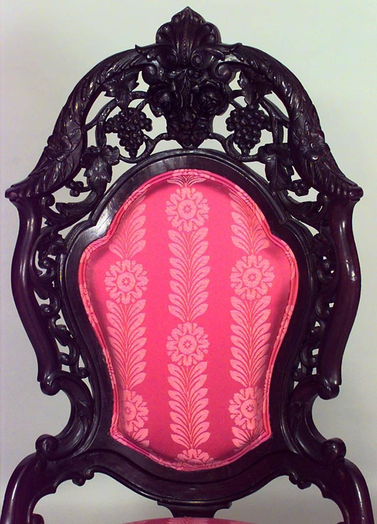 American Victorian carved rosewood and filigree side chair with floral and grape design and pink upholstered seat and back.

 